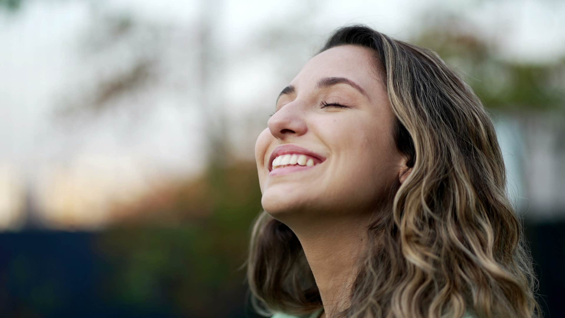 happy woman being grateful smiling