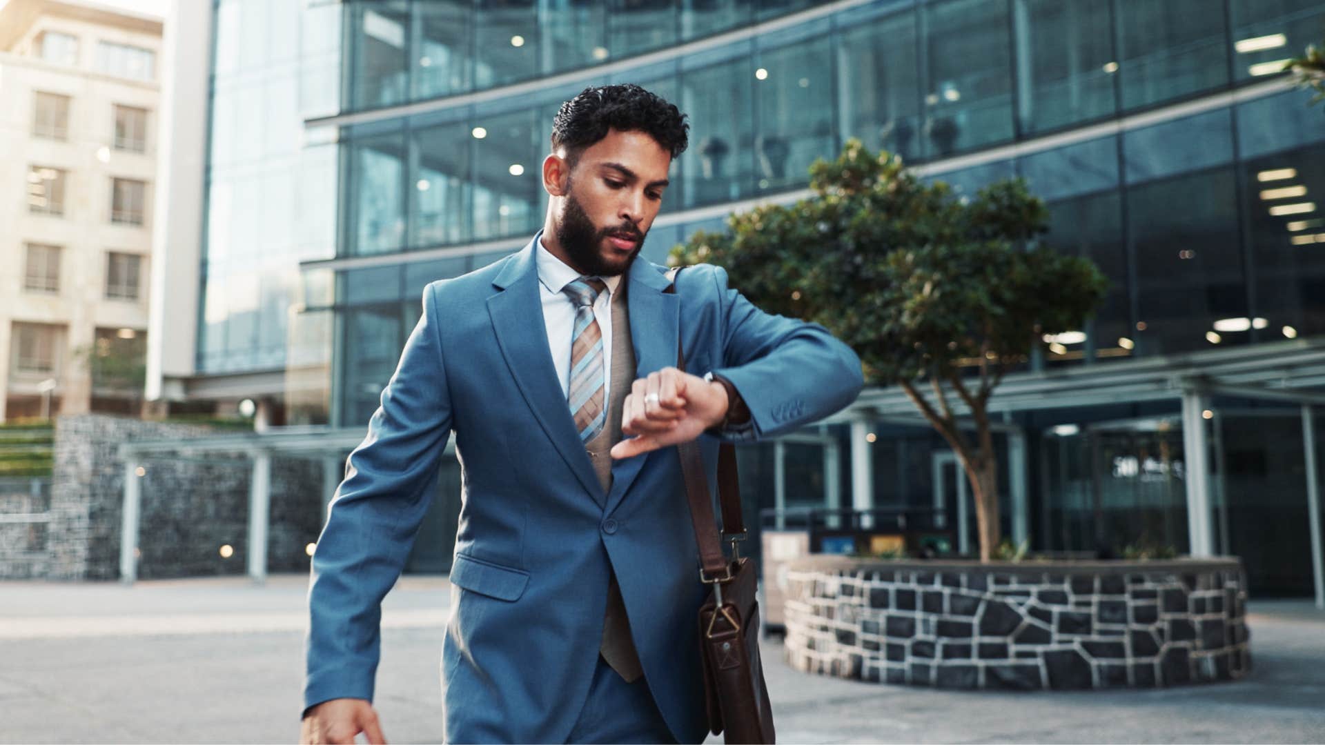 man looking at his watch not wasting what he's given