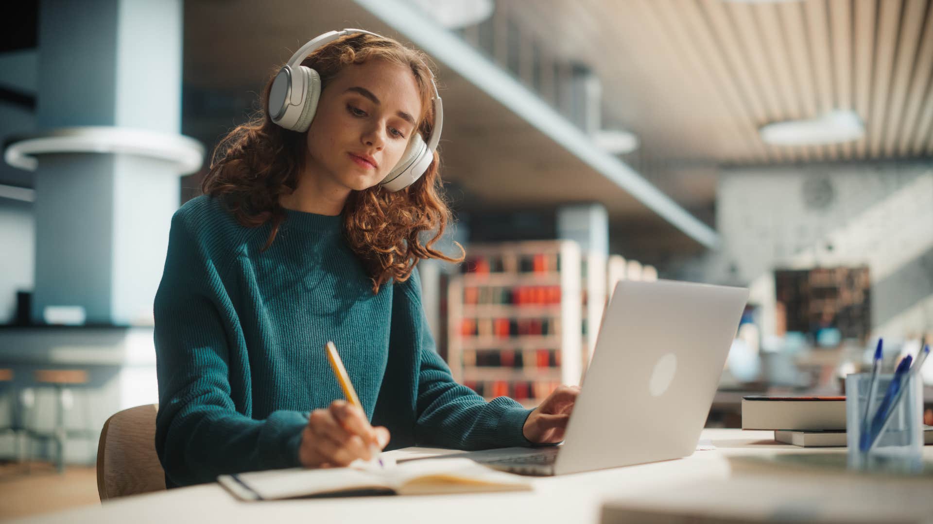 hardworking young woman finishing what she started in the library