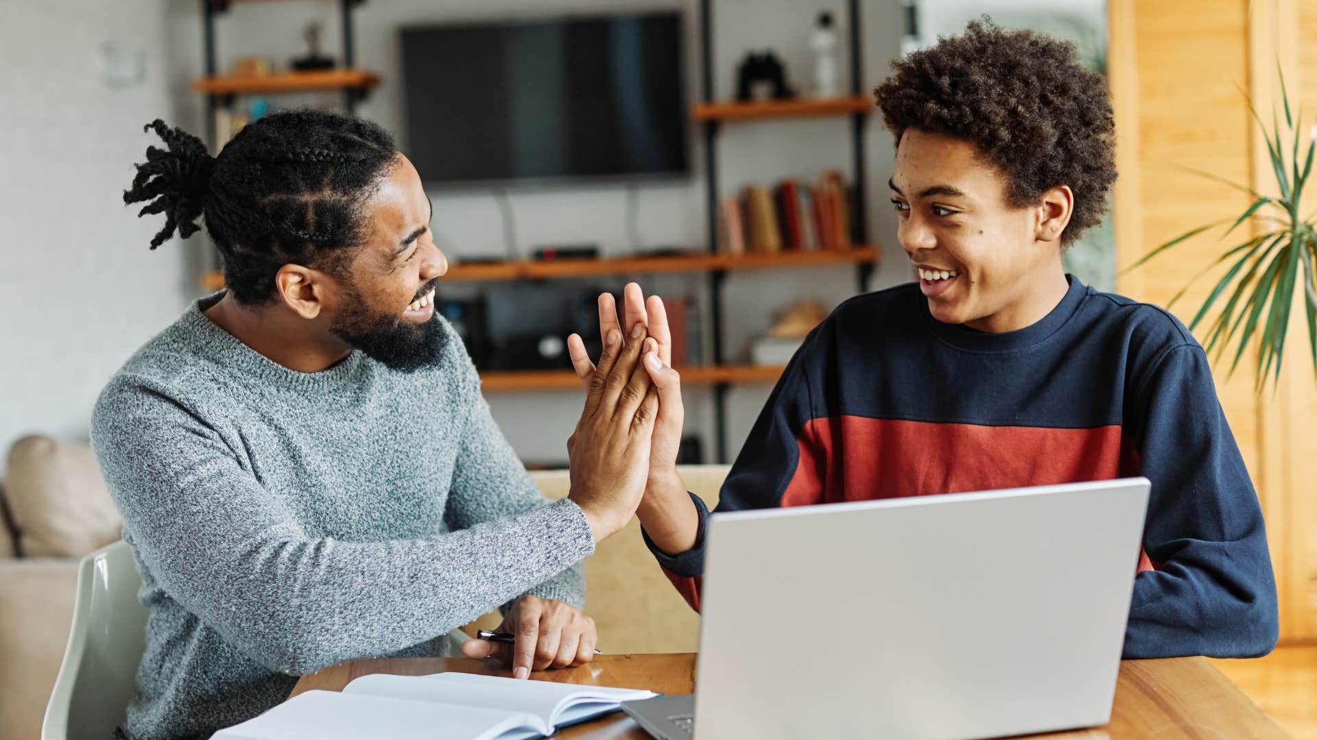 father high-fiving son always taking care of his own