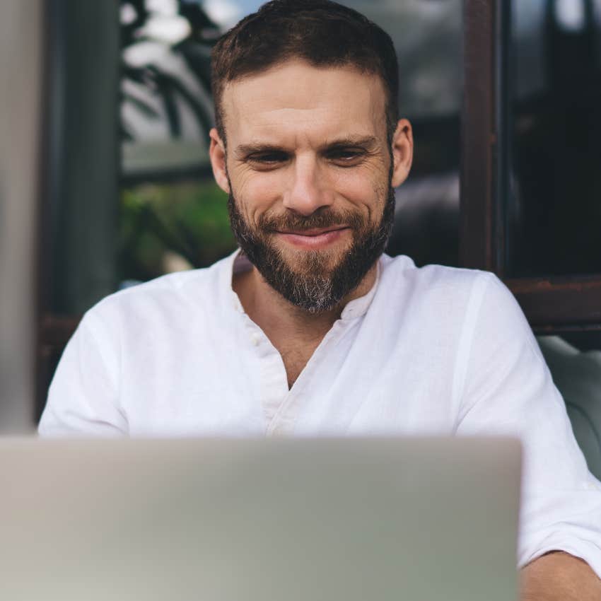 man who doesn't over-explain himself working on his laptop