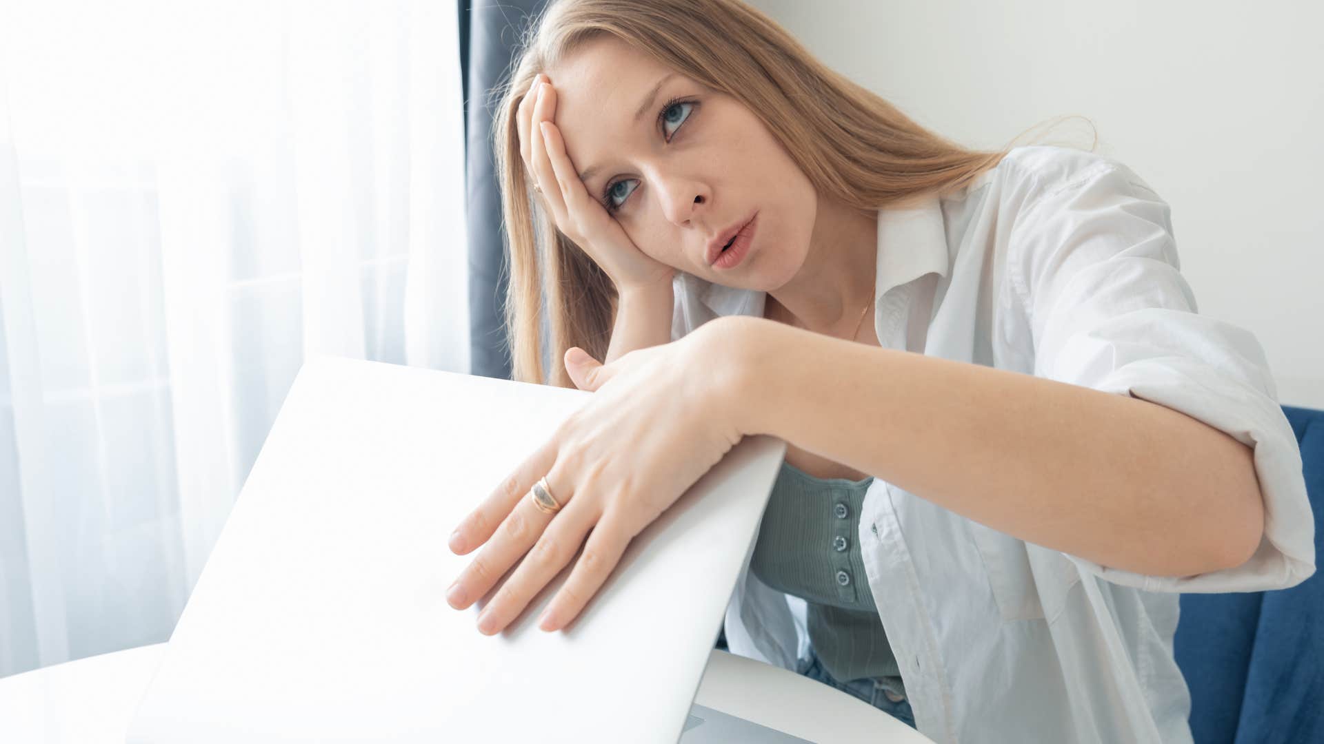 exhausted woman closing laptop