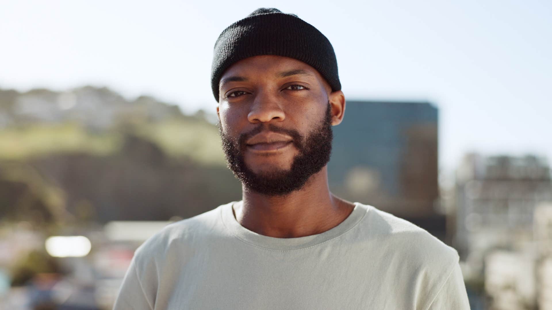 serious man standing outside looking at camera