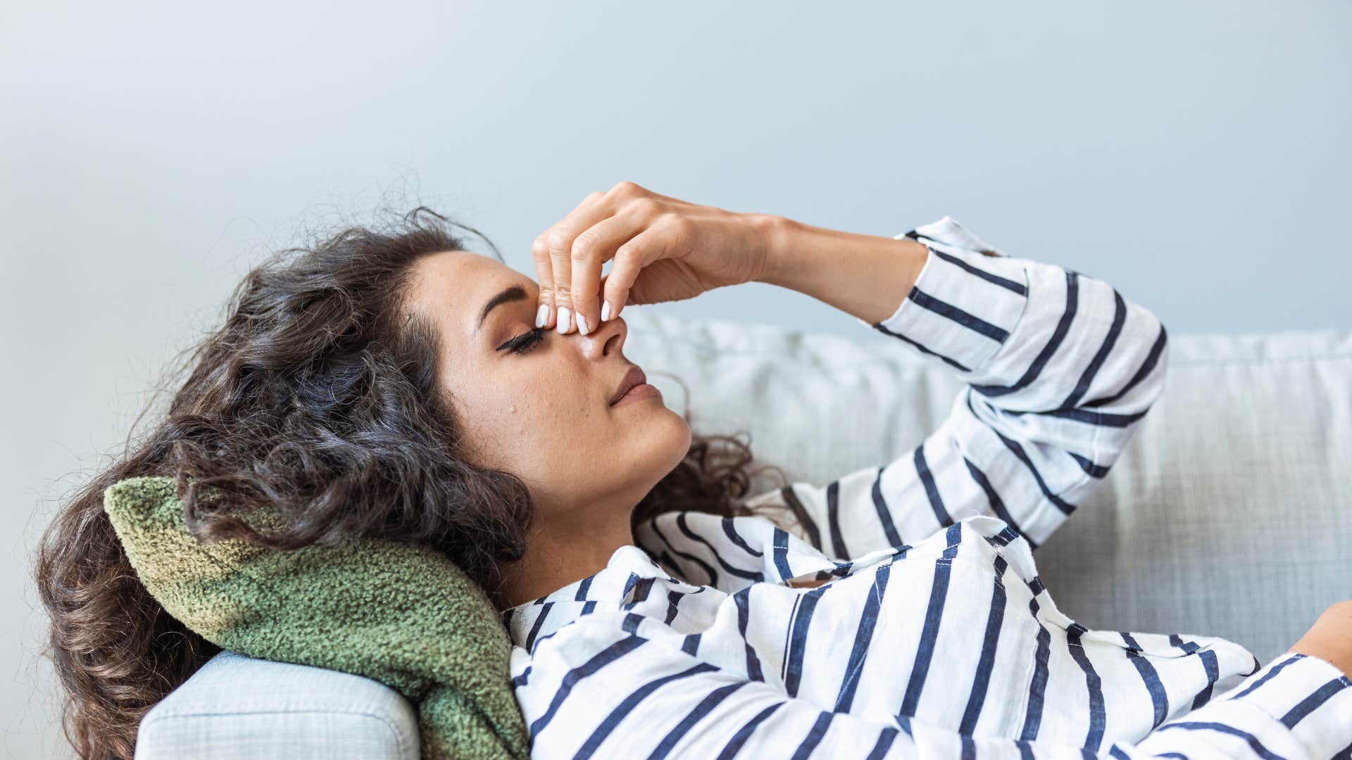 woman lying on couch trying to rest