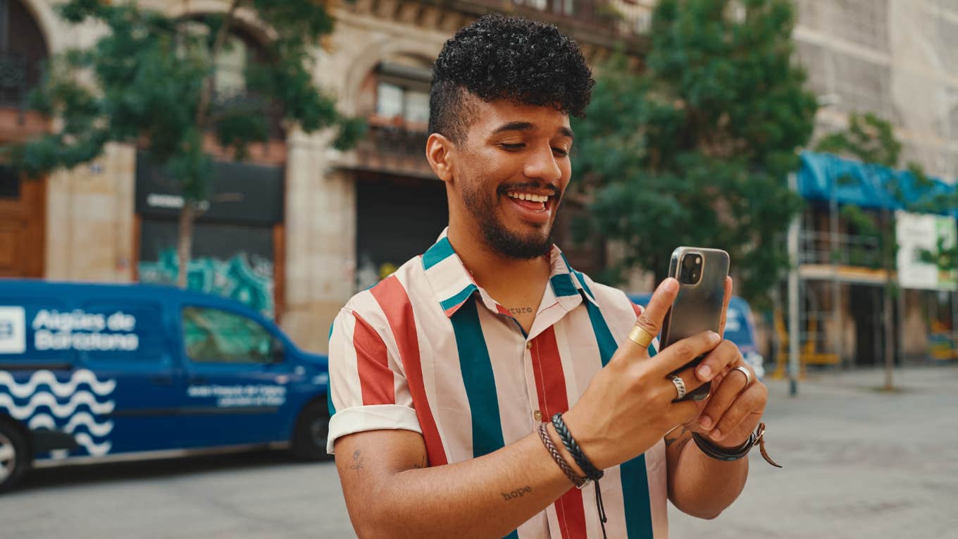 man taking photo outside on phone
