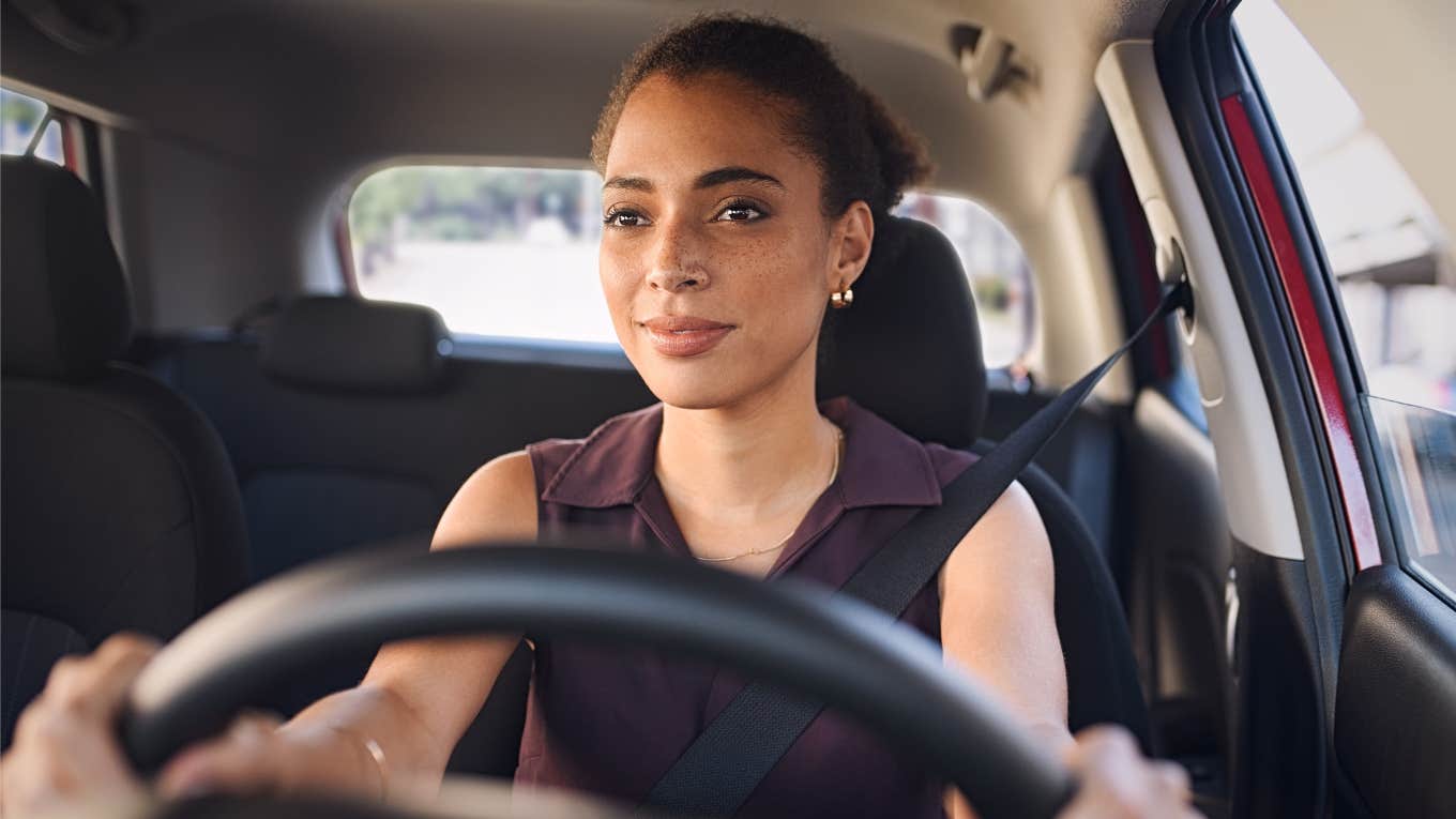woman sitting in car in silence without any music playing
