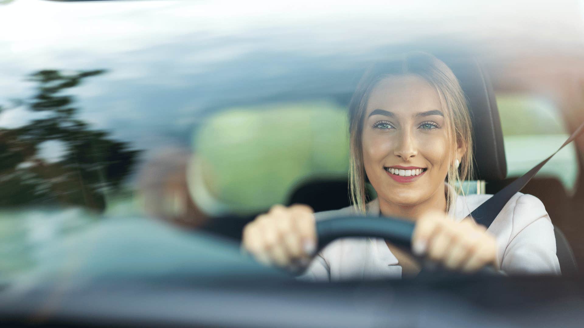 woman listening to podcast while driving