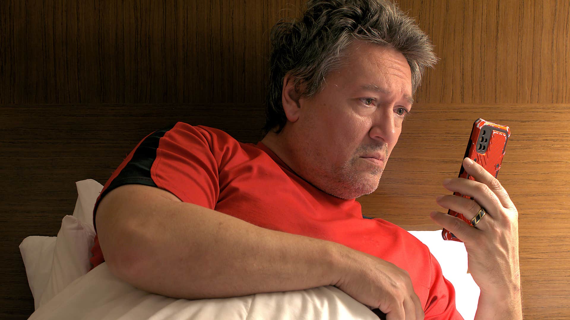 man fearing being available looking at his phone