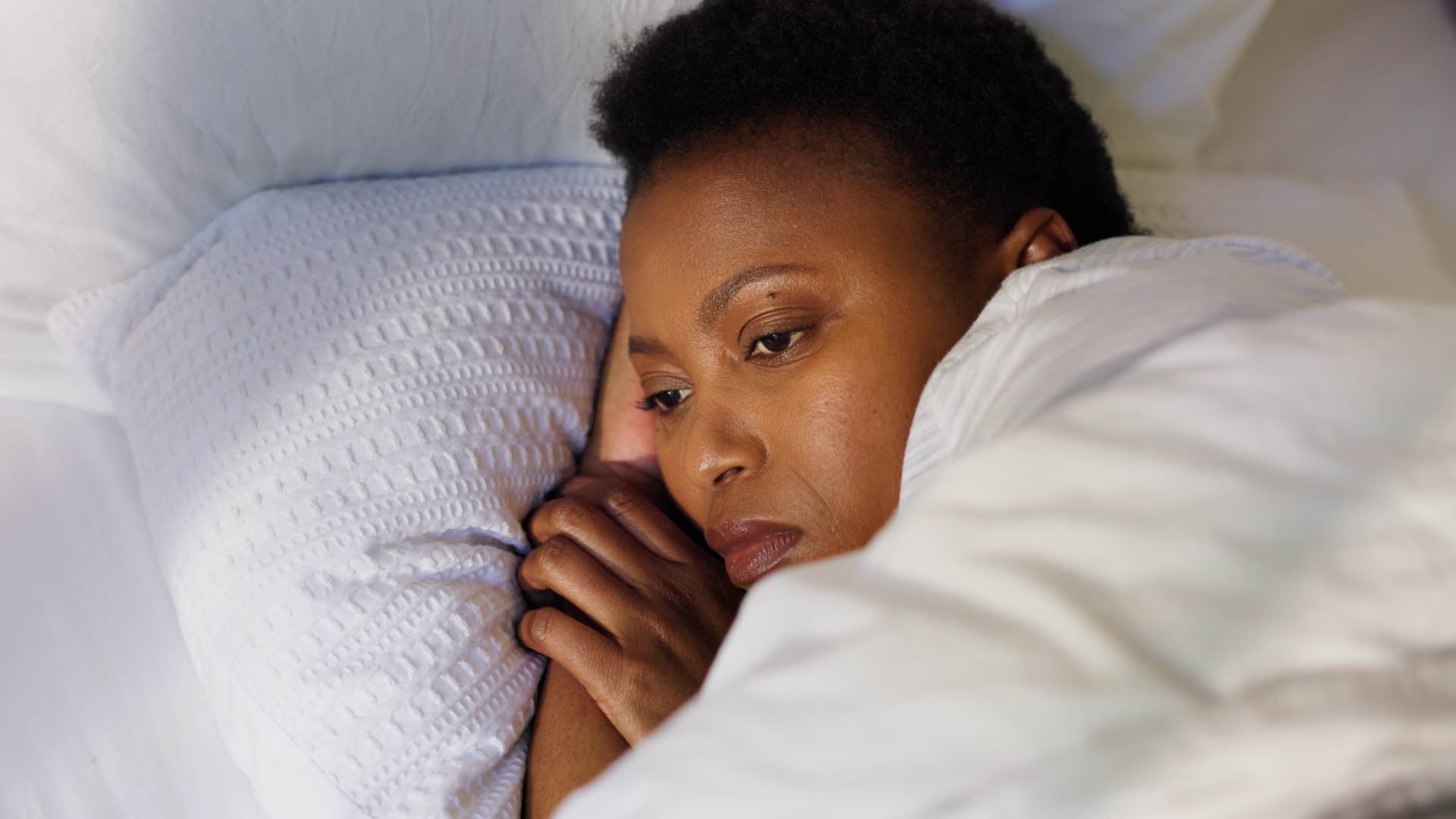 woman feeling restless in bed
