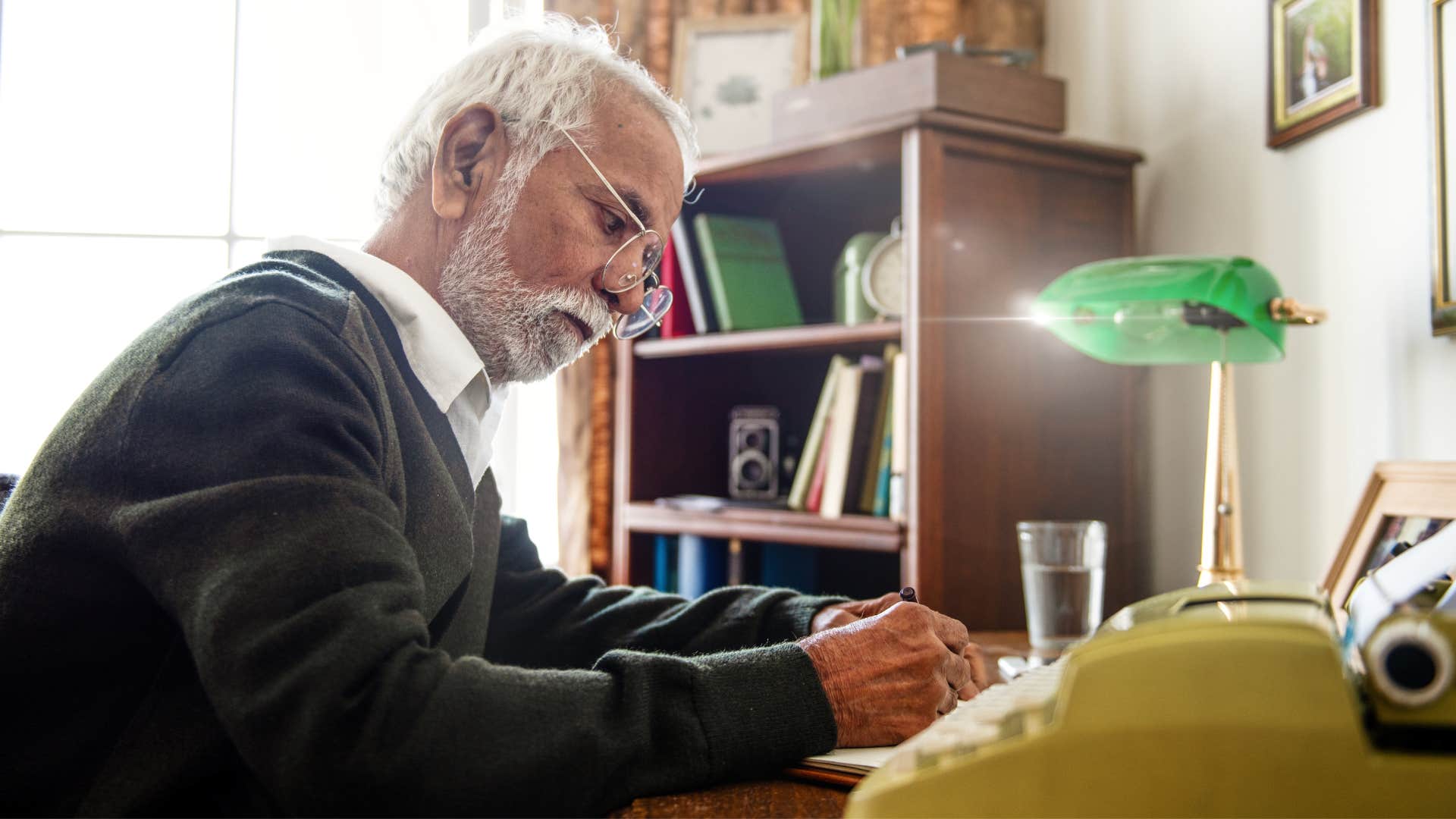 caring man at his desk writing
