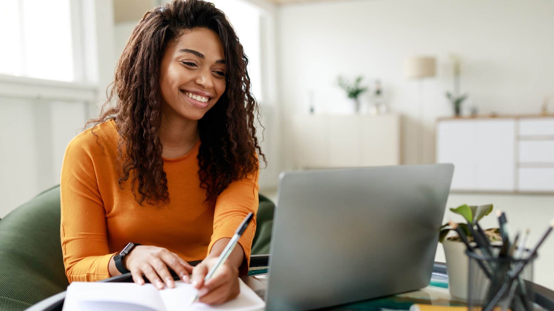 loyal woman writing in her notebook at home