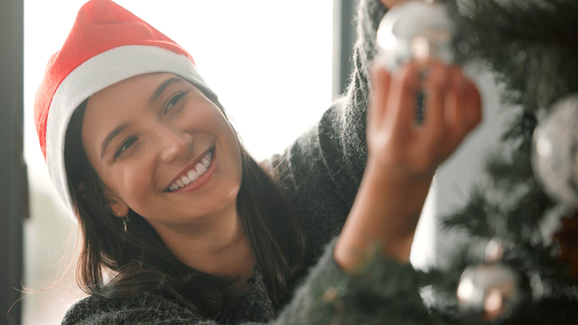 woman making space for healthy nostalgia putting up holiday decorations