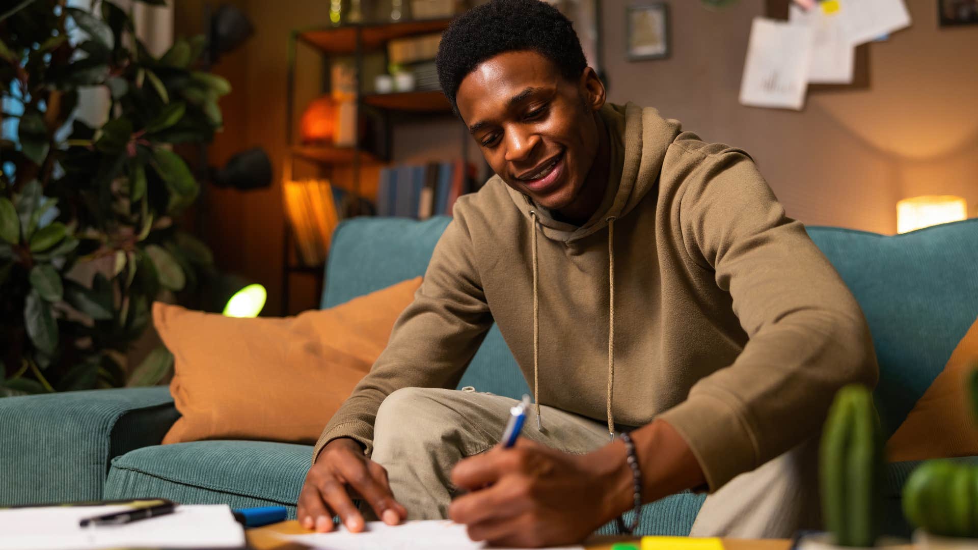 man who's an old soul writing holiday cards at home