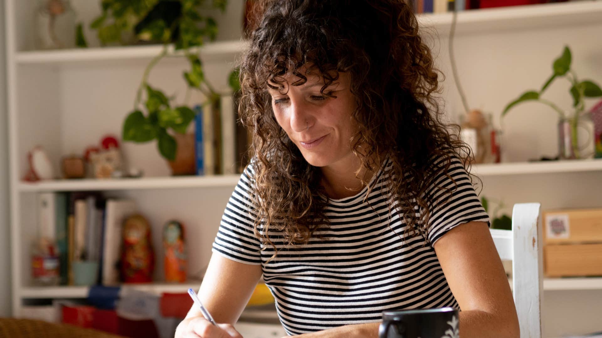 patient woman writing holiday cards at home