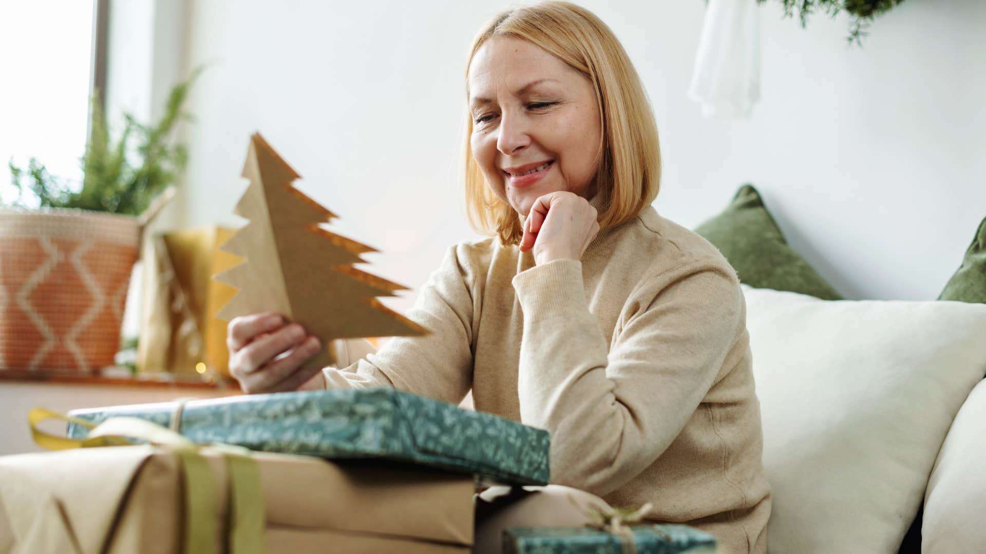 thoughtful woman being quietly generous making holiday cards