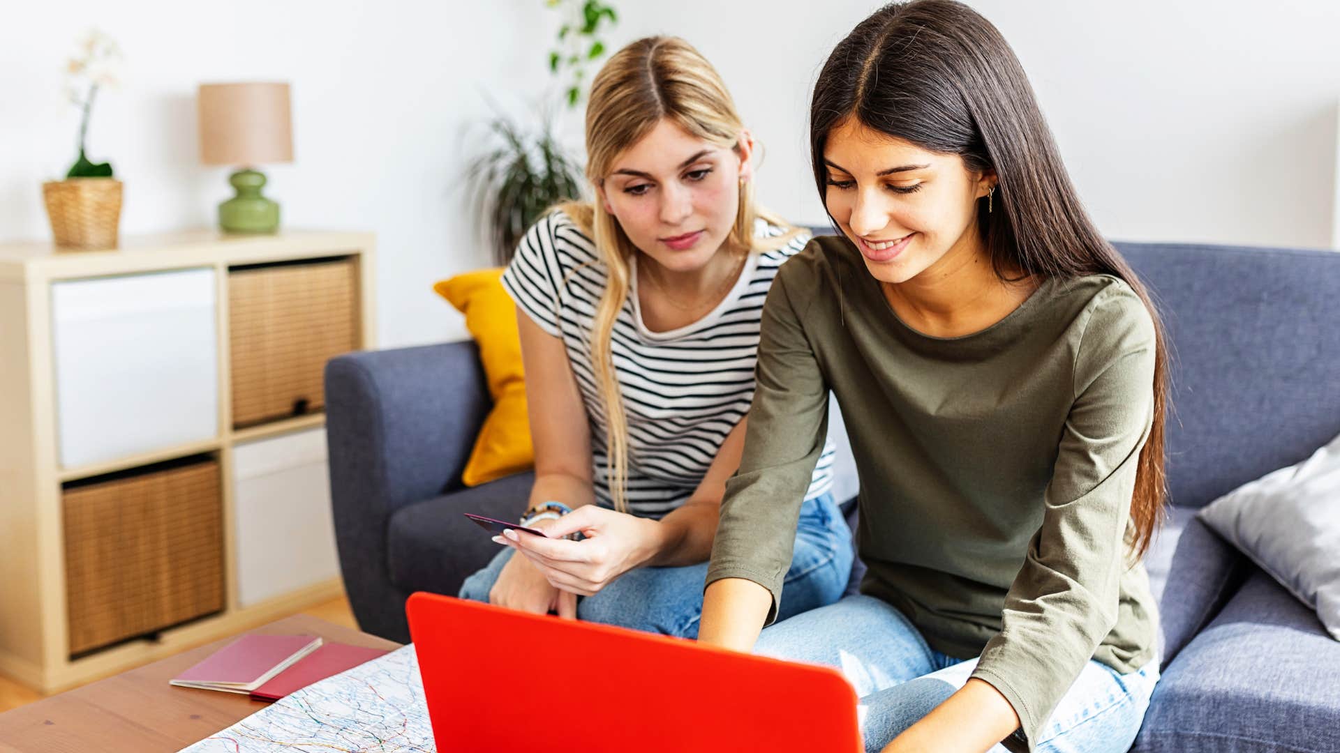 Sentimental women smiling while buying holiday cards.