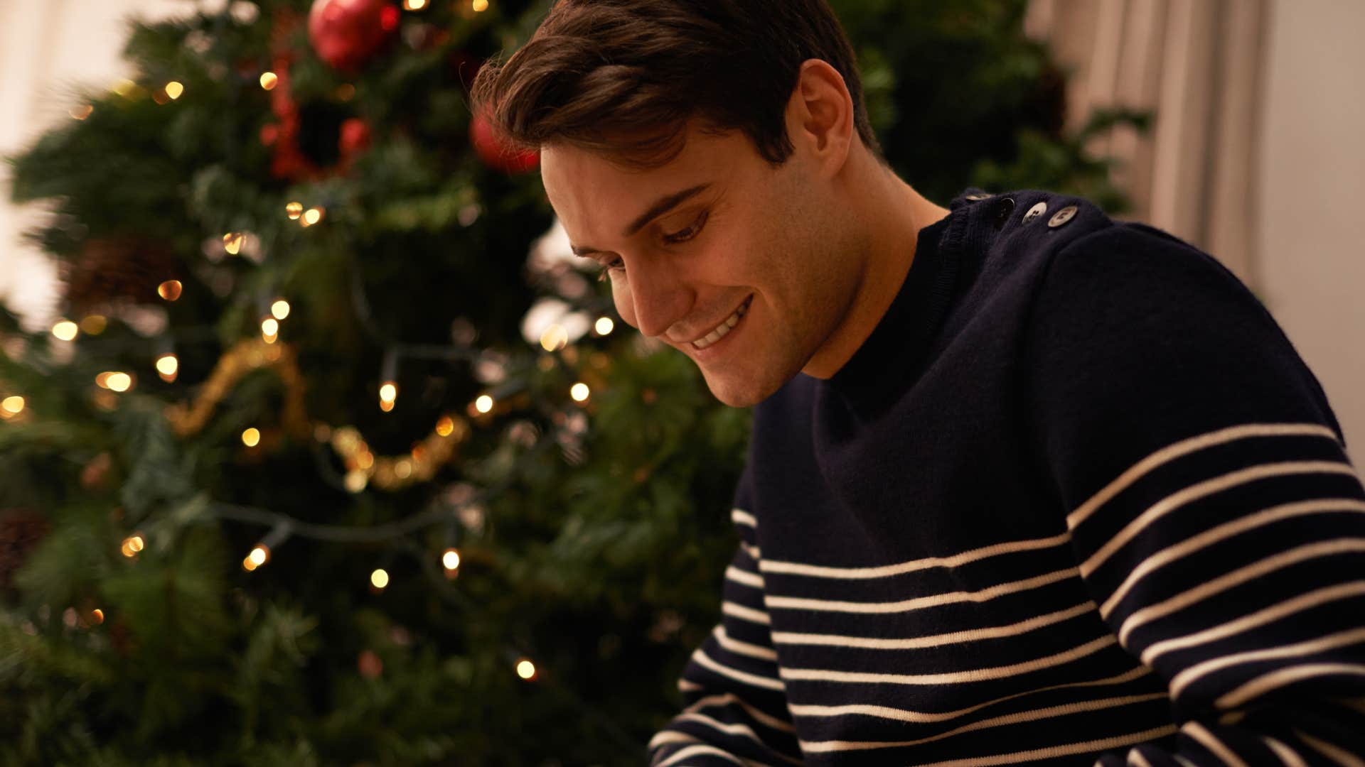 thoughtful man sitting at home writing cards