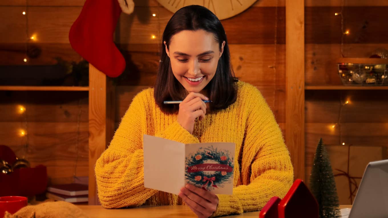 happy festive woman writing holiday cards
