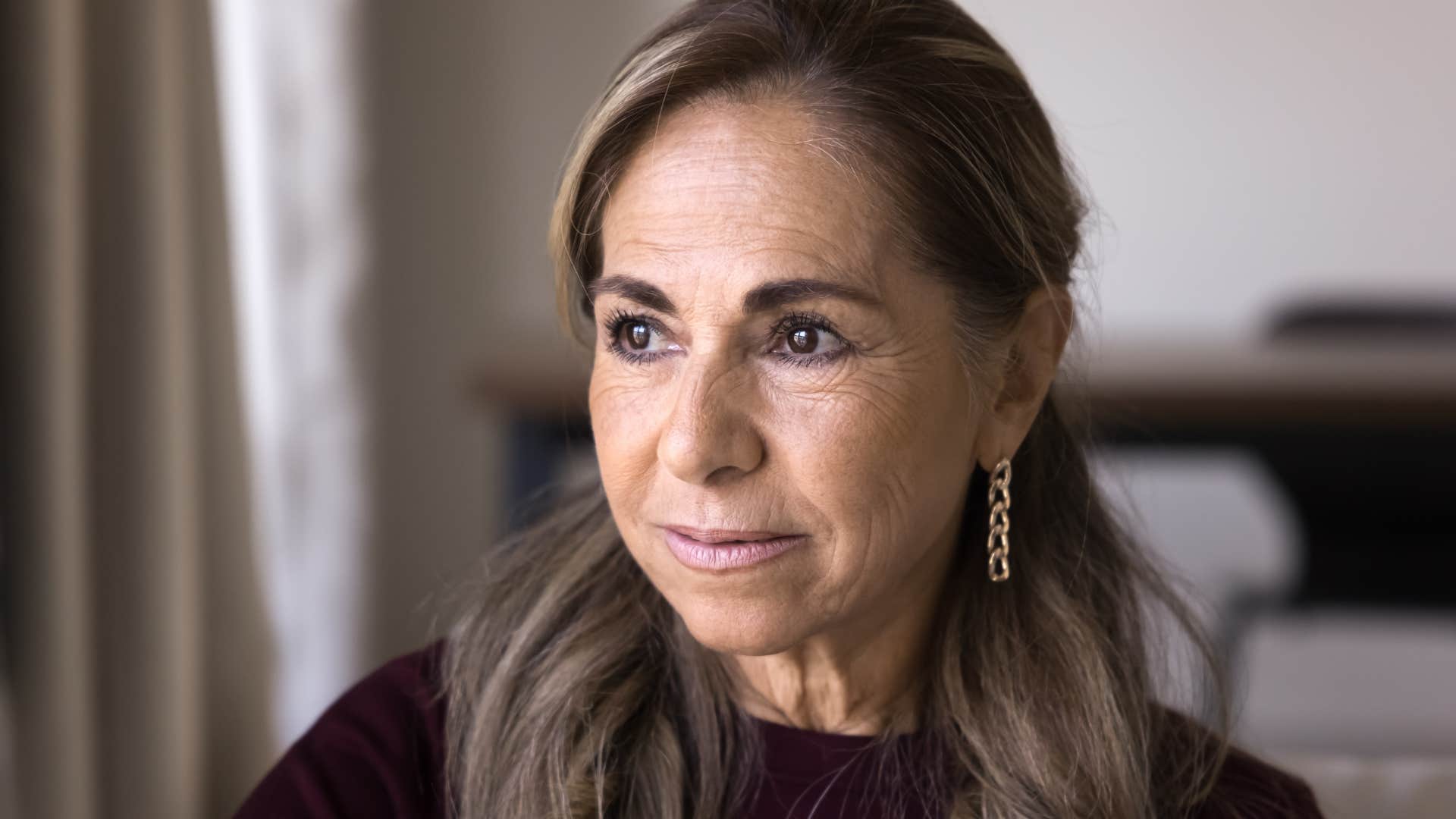 woman highly sensitive to group energy sitting at home alone