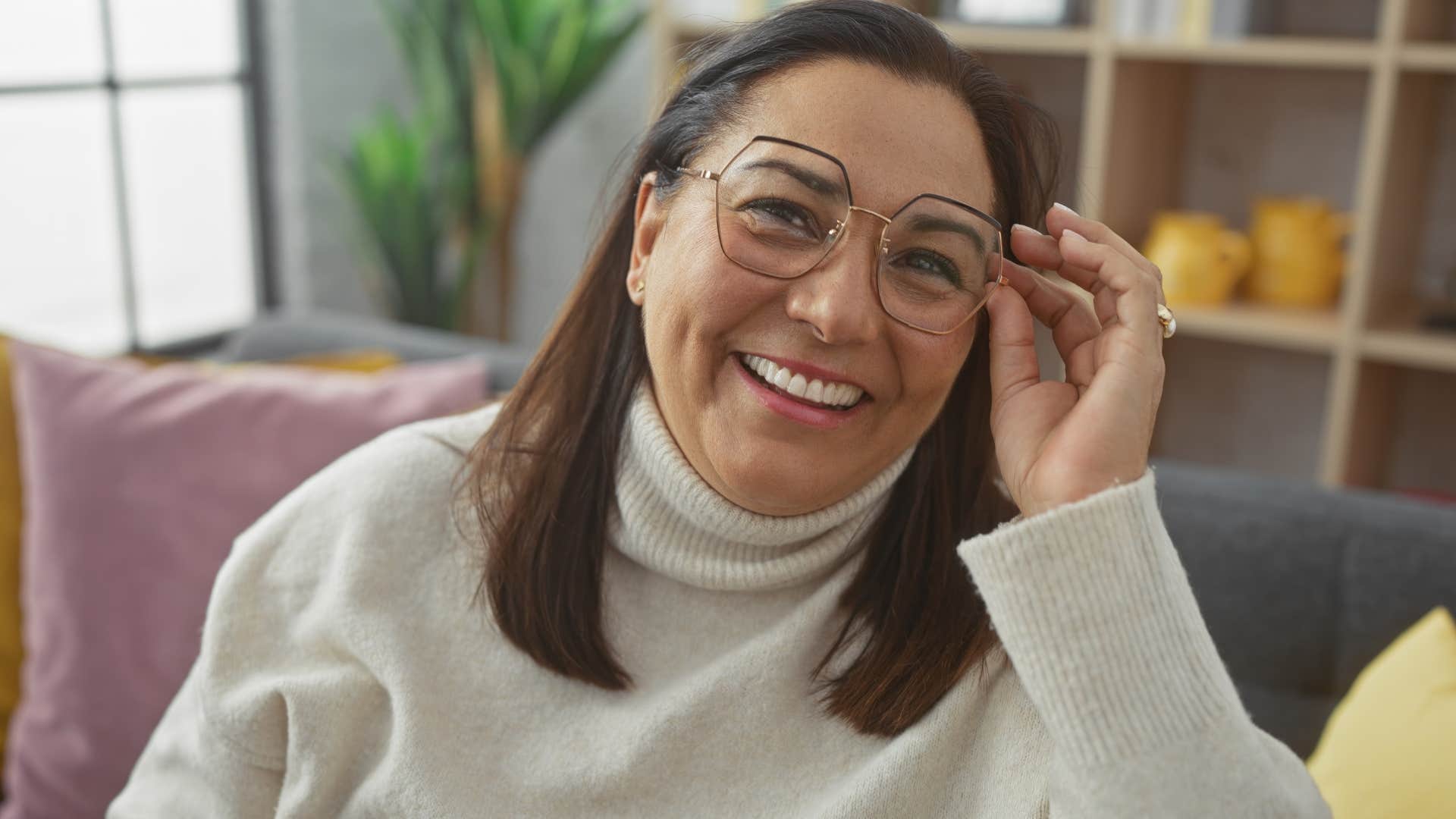 woman ignoring phone and smiling at home