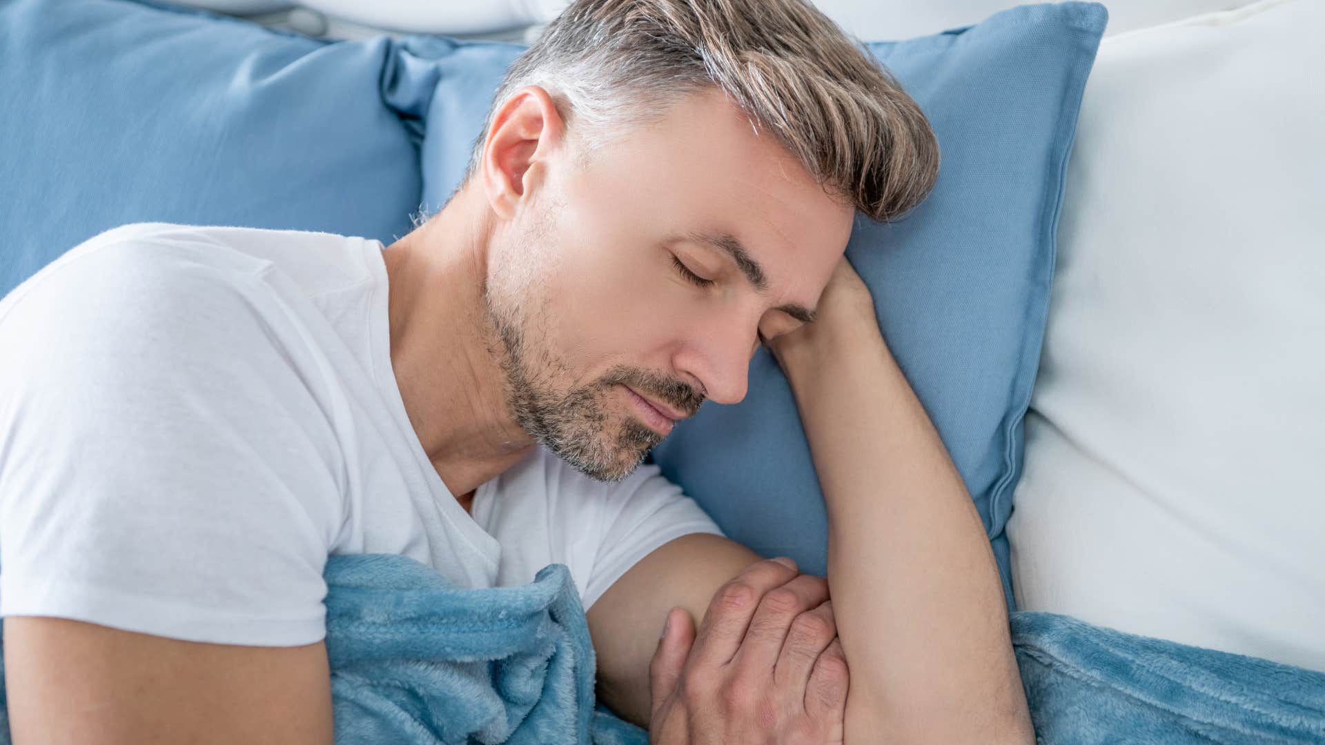 man not equating rest to laziness as he naps in bed