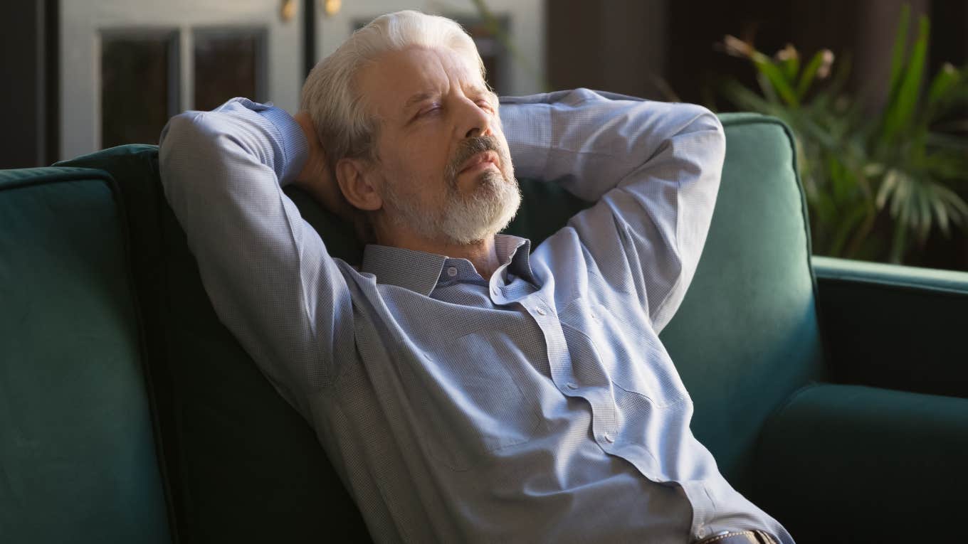 older man peacefully napping on his couch alone