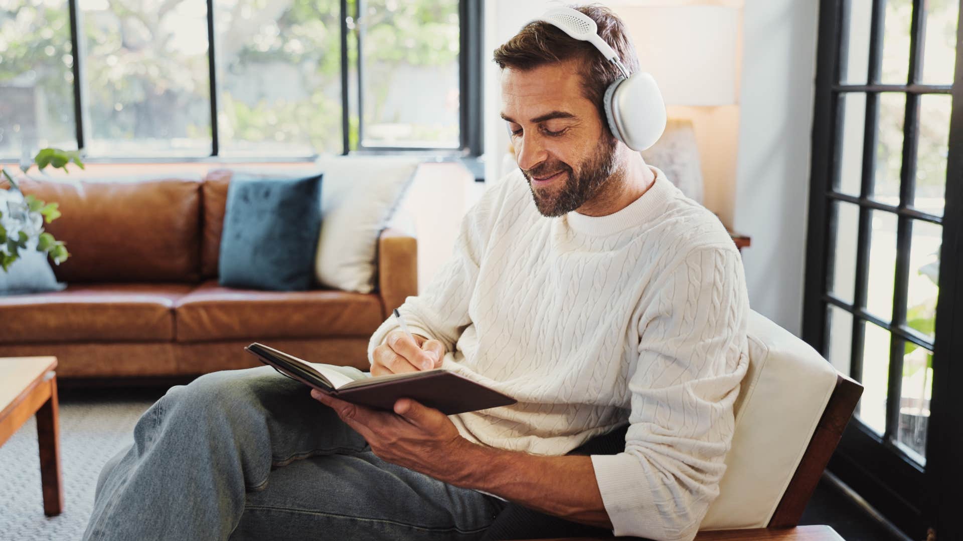 man journaling in a reflective way at home