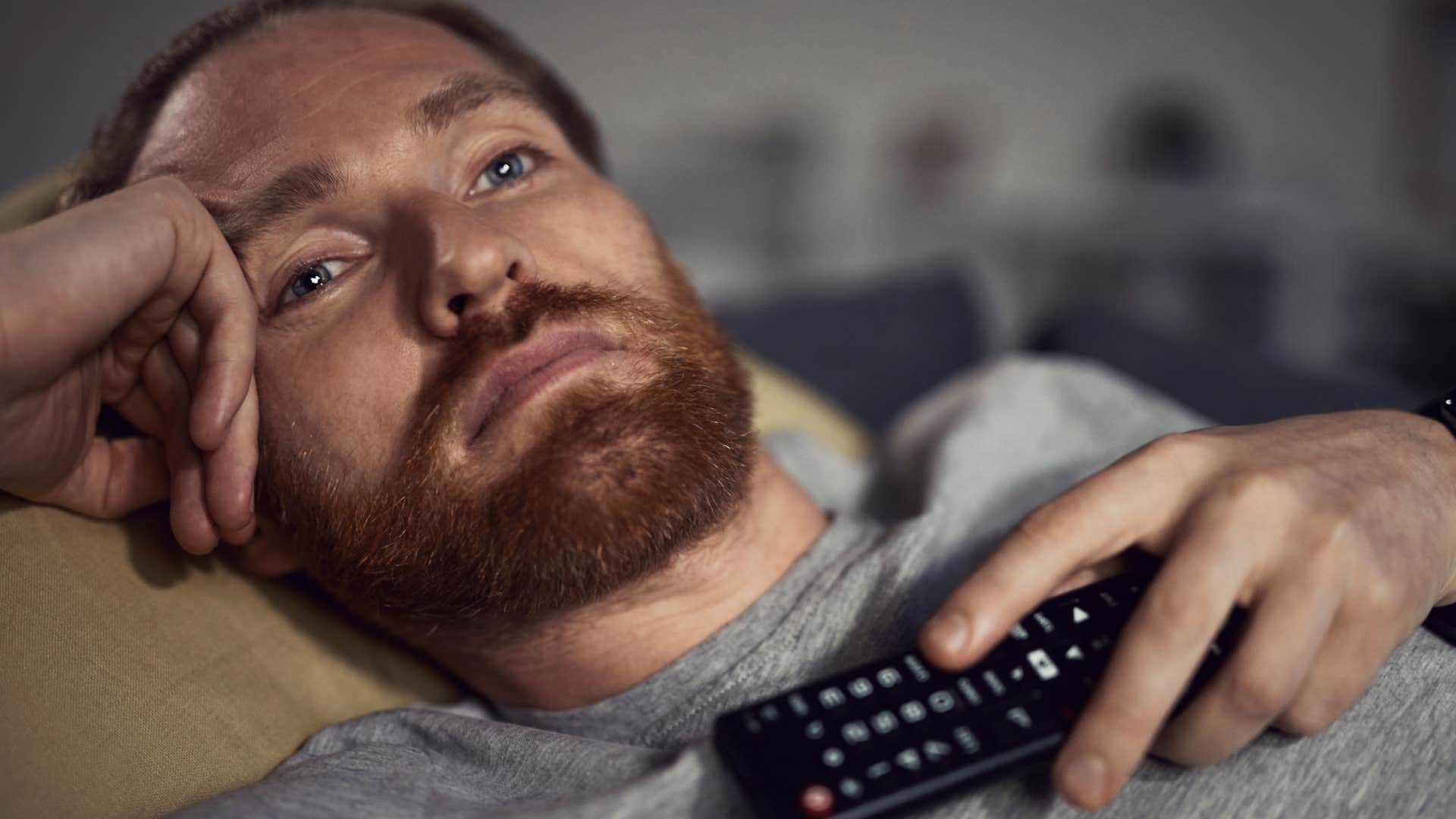 sad man watching his comfort shows 