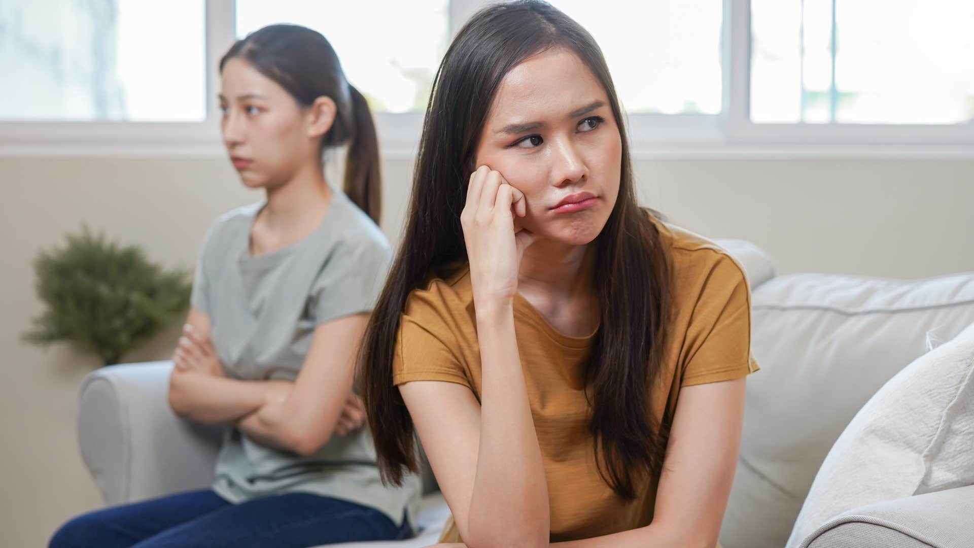 sad woman growing irritable with friend