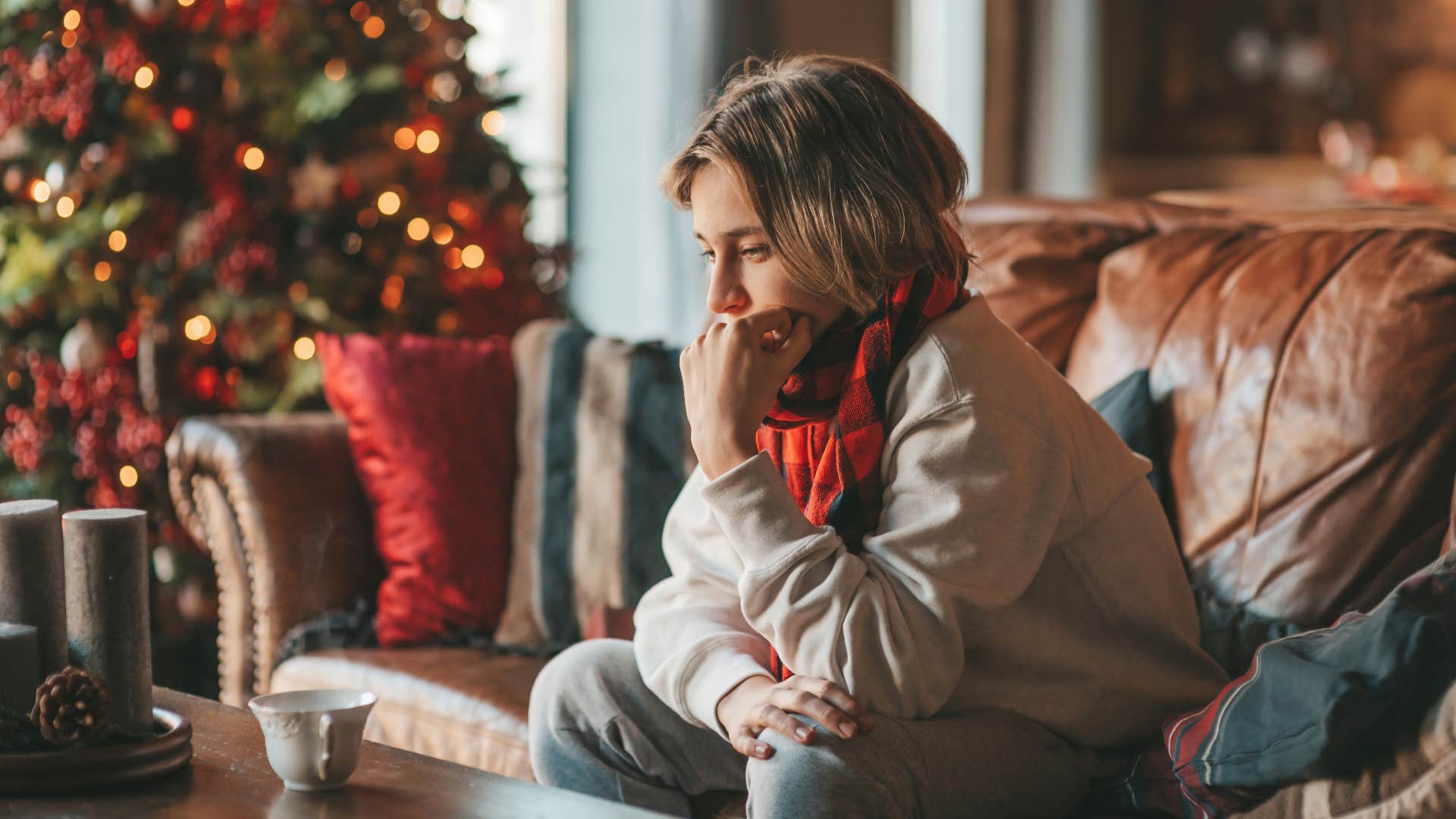 young man feeling nostalgic among christmas decor