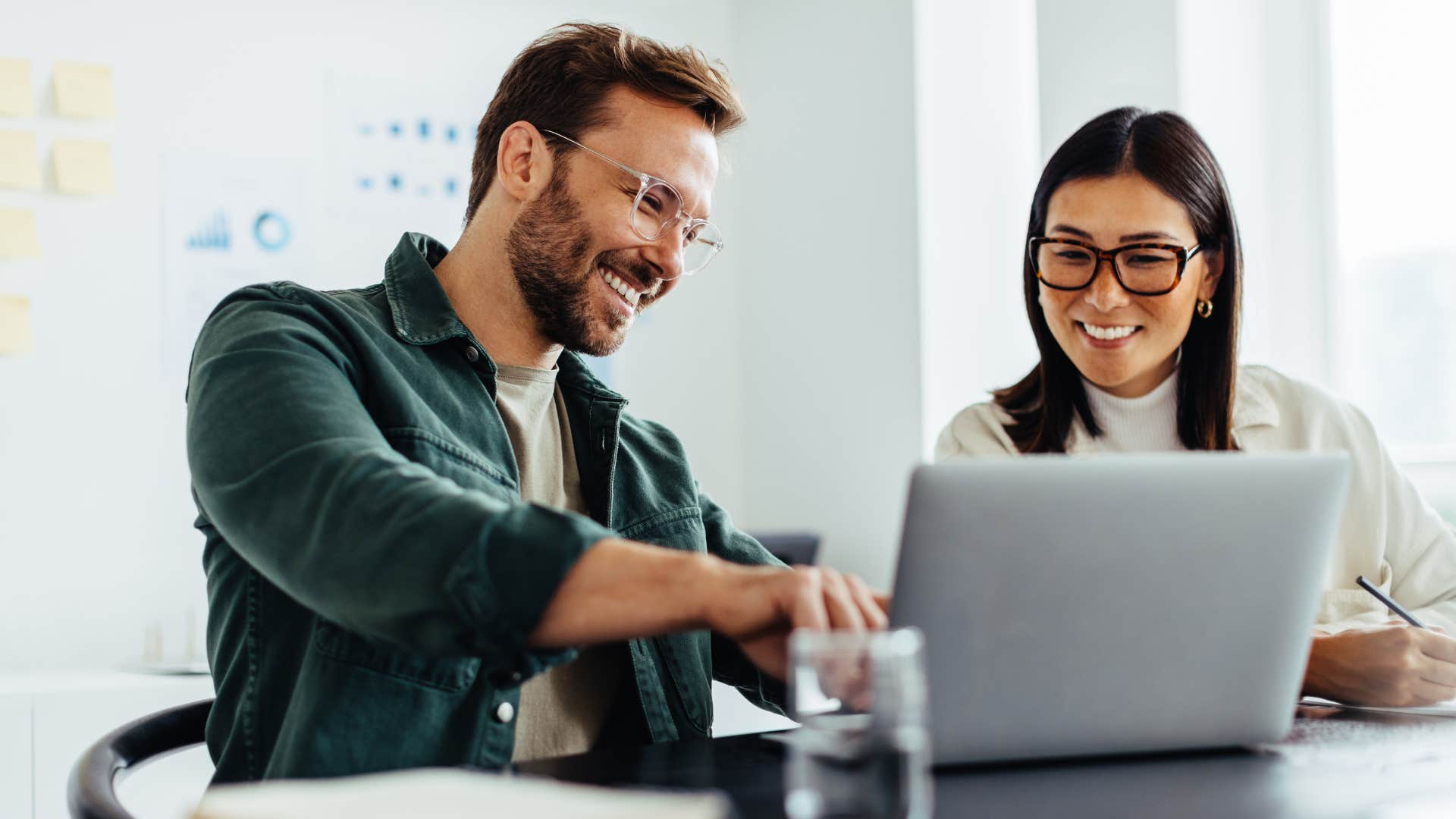 man asking colleague for help at work