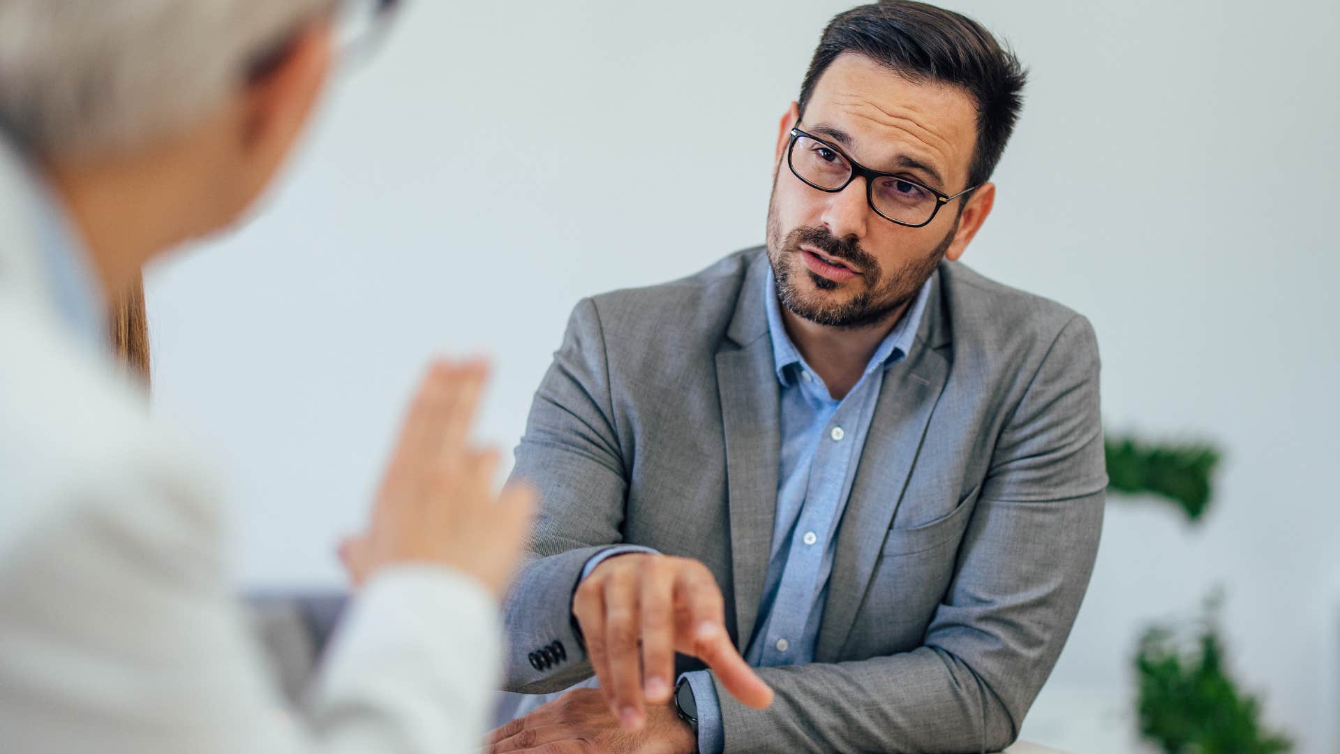 defensive man changing his mind at work