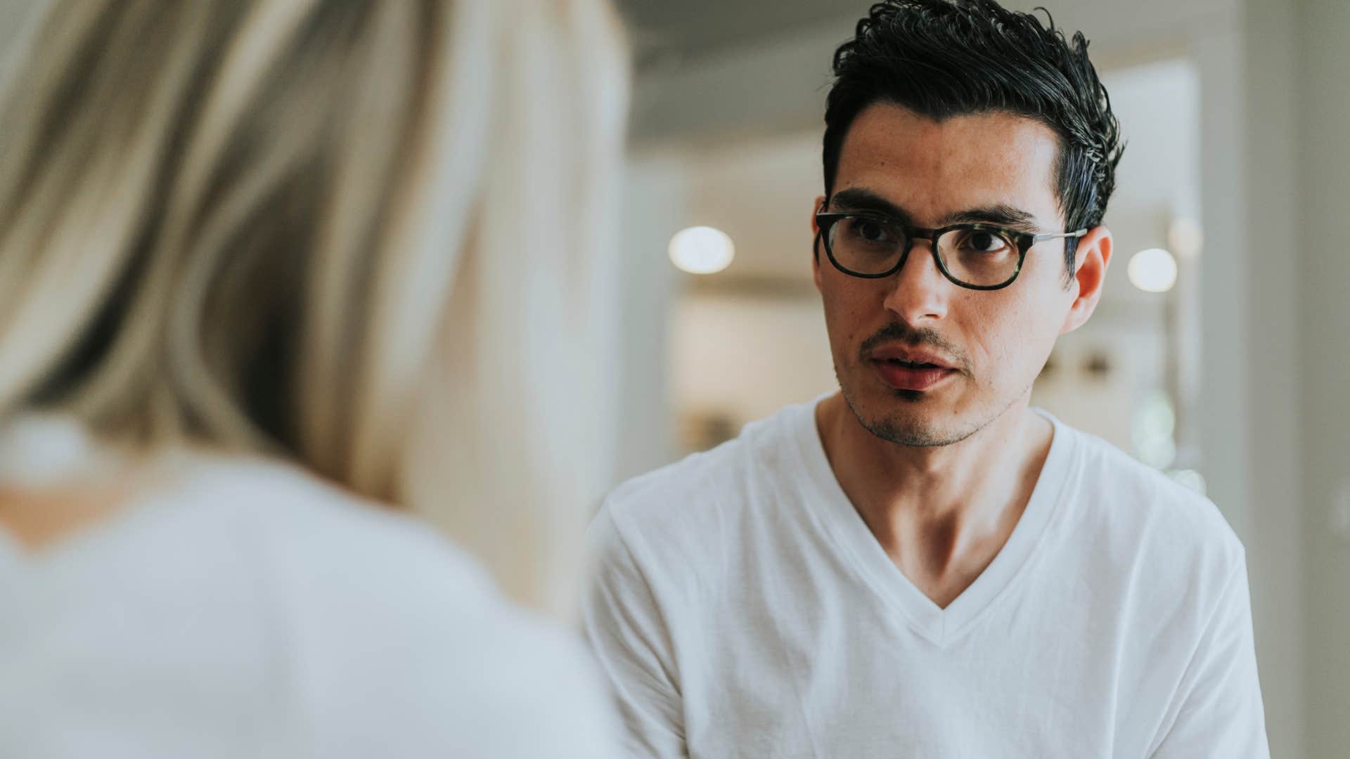 man getting defensive over woman's follow-up questions