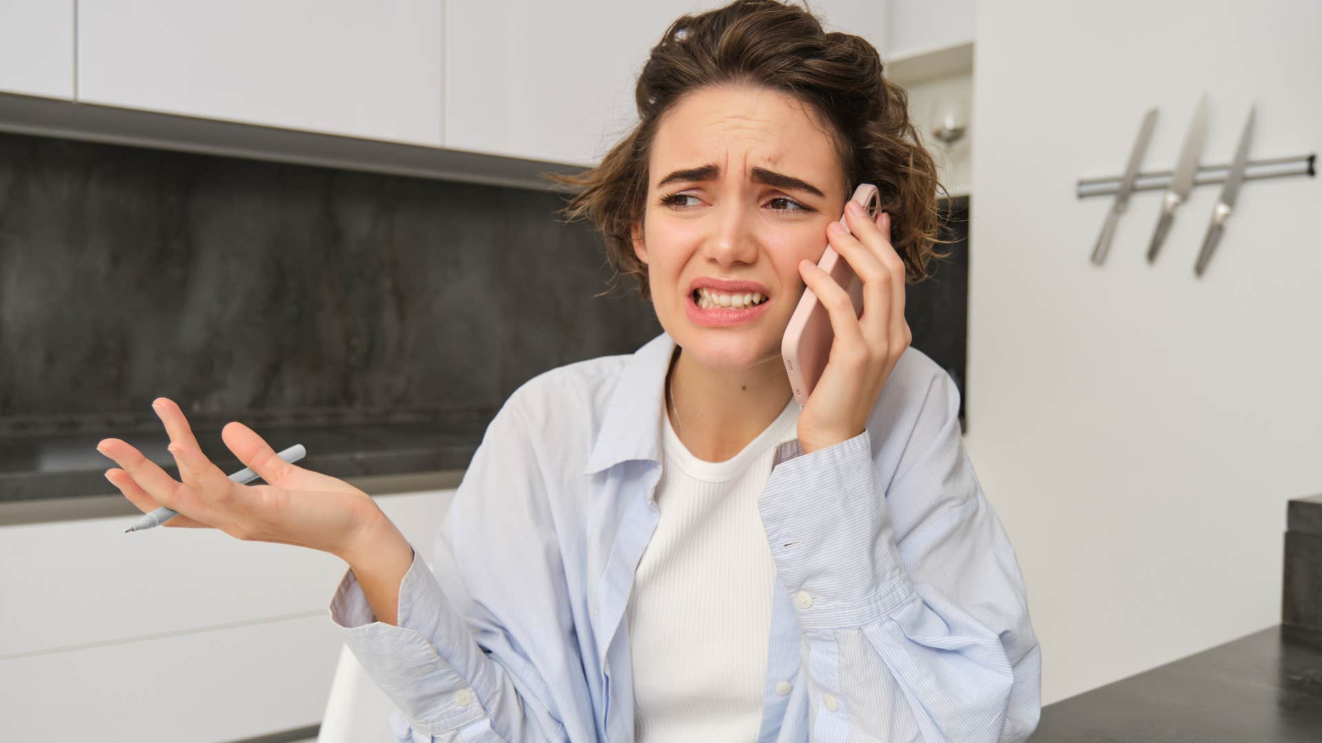 woman looking uncomfortable with silence on her phone