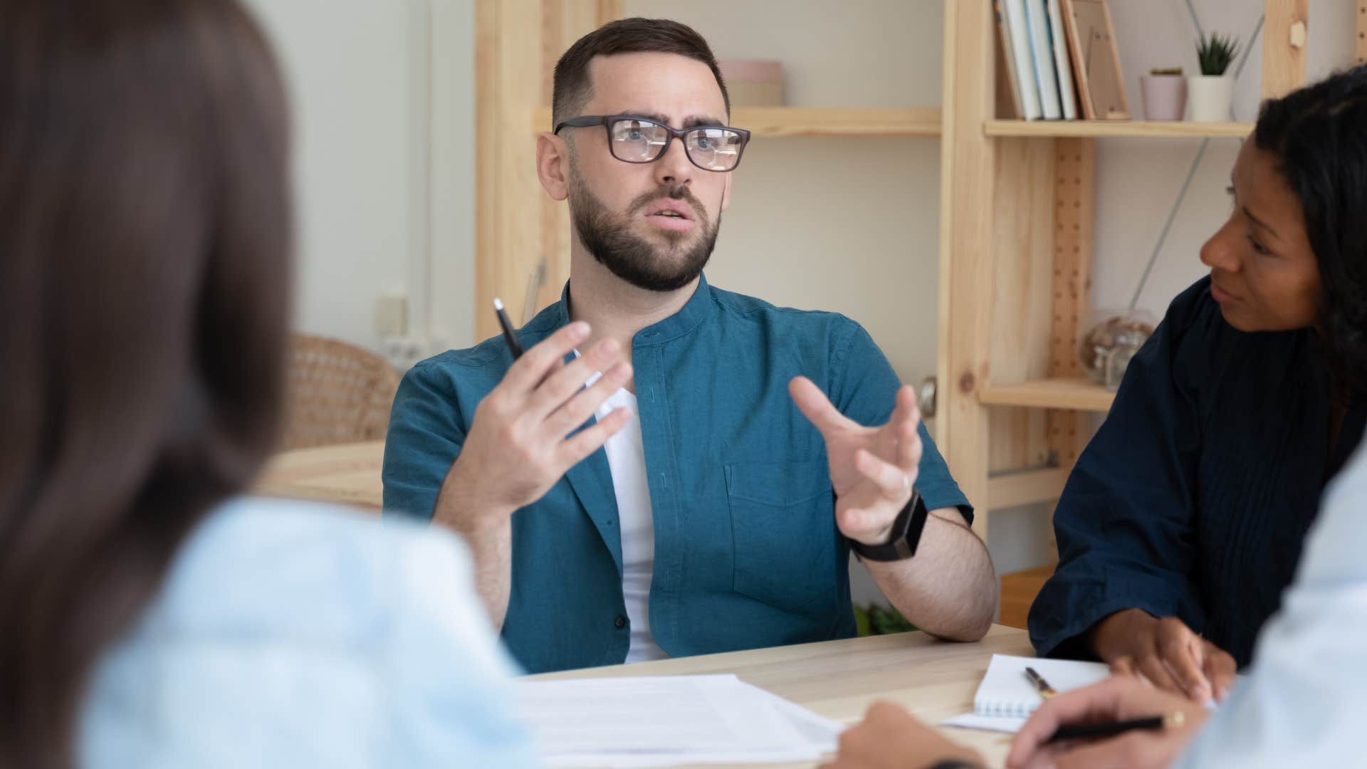 Man saying from an intellectual standpoint in a work meeting