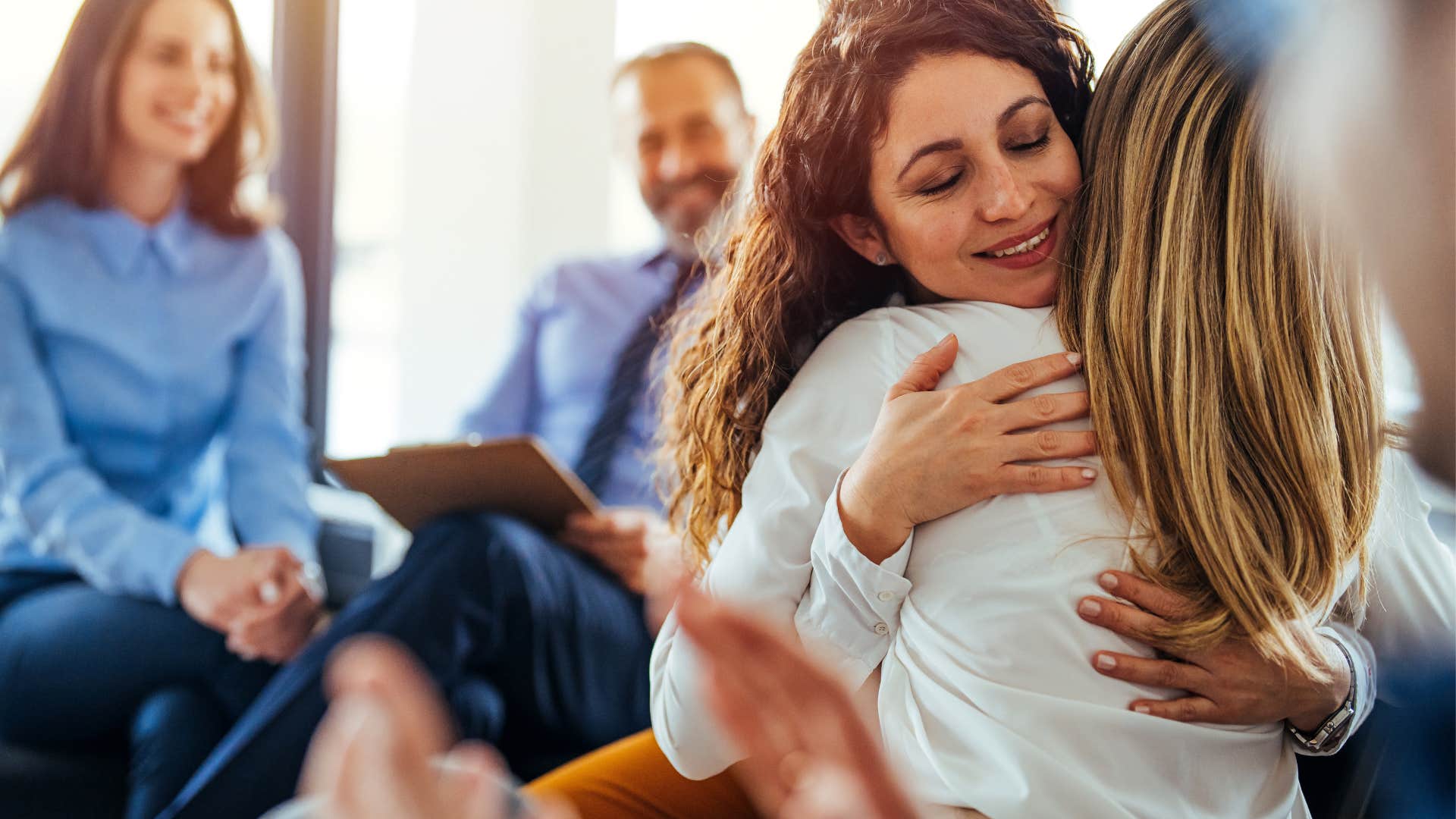 woman hugging friend helping her