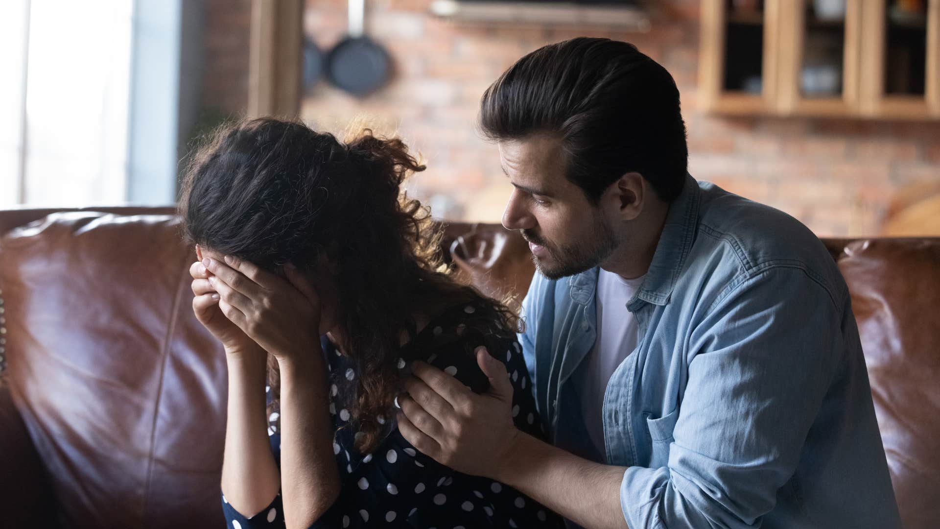 man comforting woman telling her shes not alone