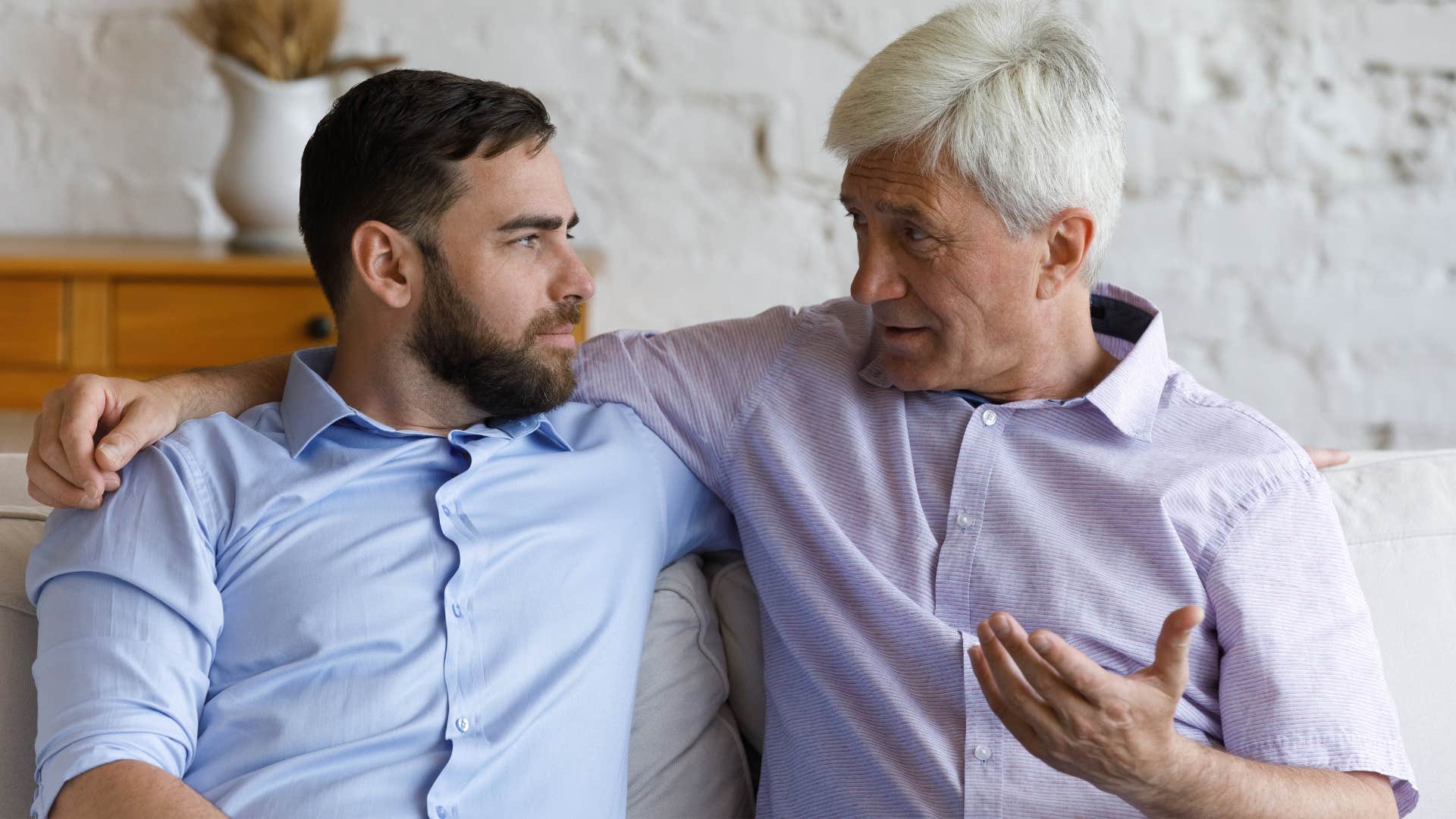 Man saying "we don't have to agree" to his adult son.