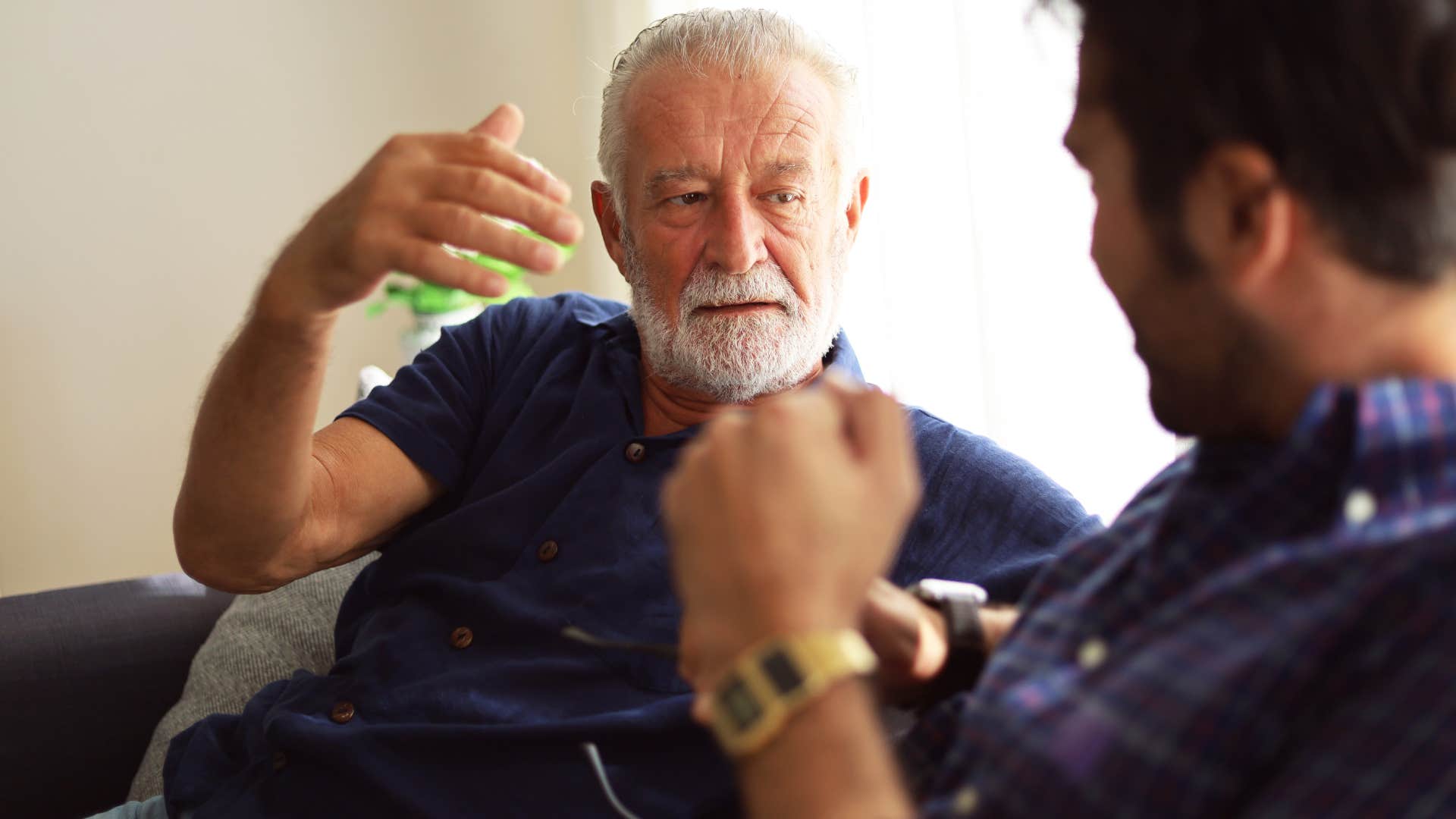 Man saying "we're on the same team" to his adult son.