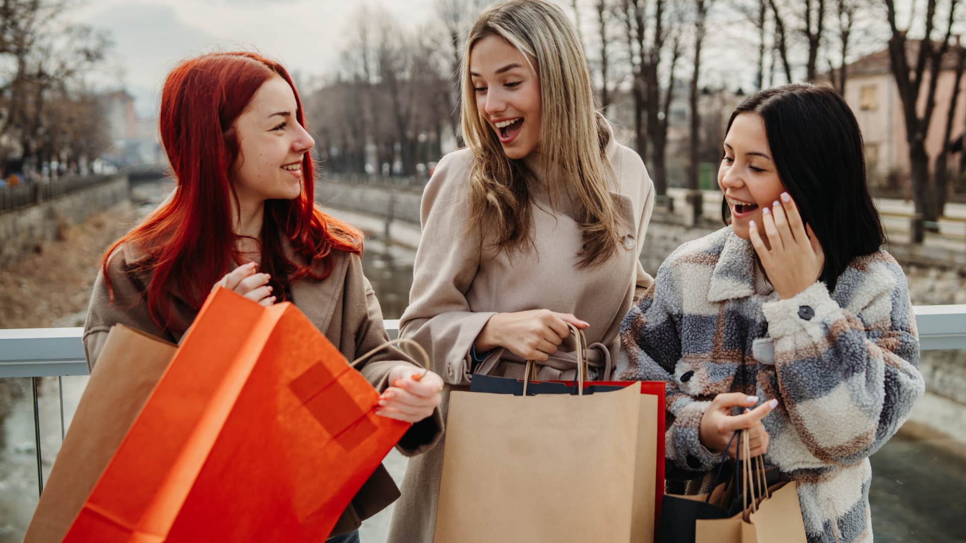 wealthy group of friends looking at bags after shopping