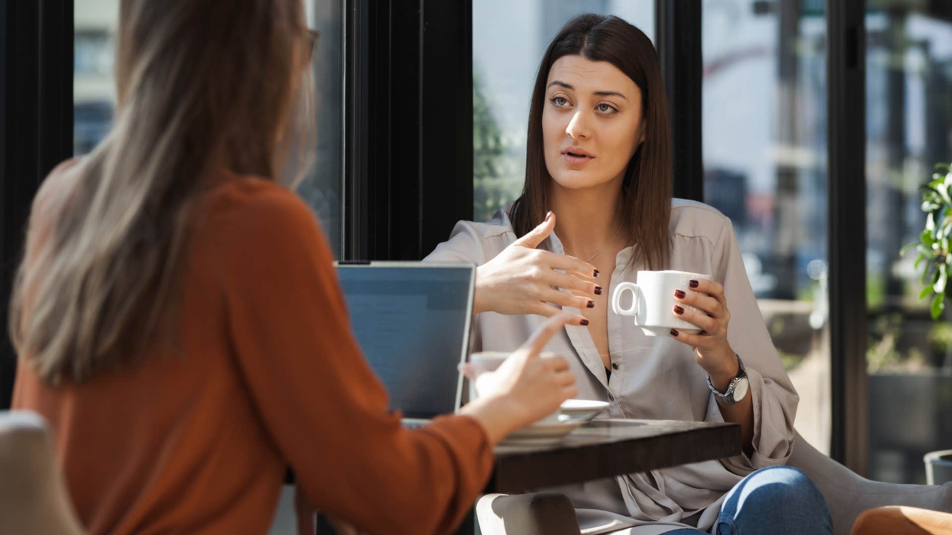 wealthy woman making suggestion to friend about finances
