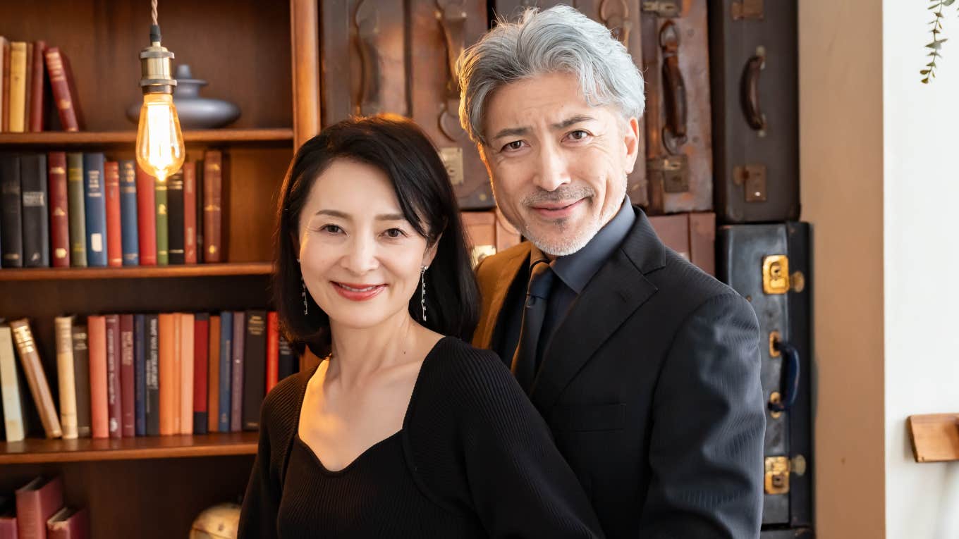 upper class wealthy people standing in big study