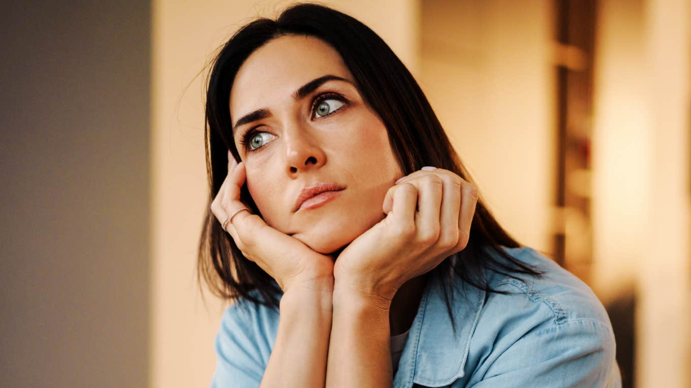 adult sitting in quiet reflection with a distant, heavy expression, capturing the core emotional indicator psychologists say points to childhood emotional neglect