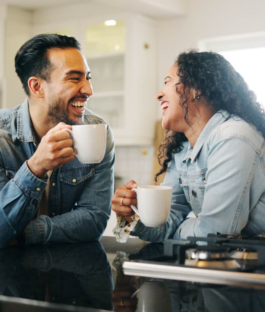 Laughing couple spend time together showing good relationship