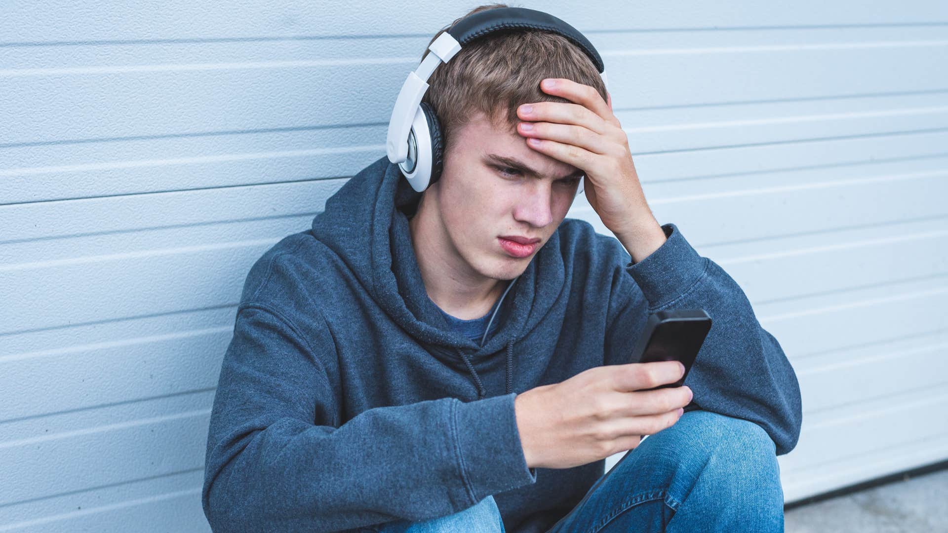 lonely gen z man who's not dating looking at his phone