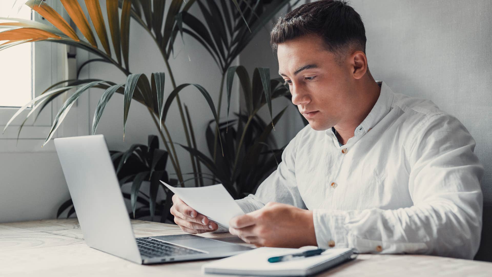 stressed gen z man doing bills struggling with student debt