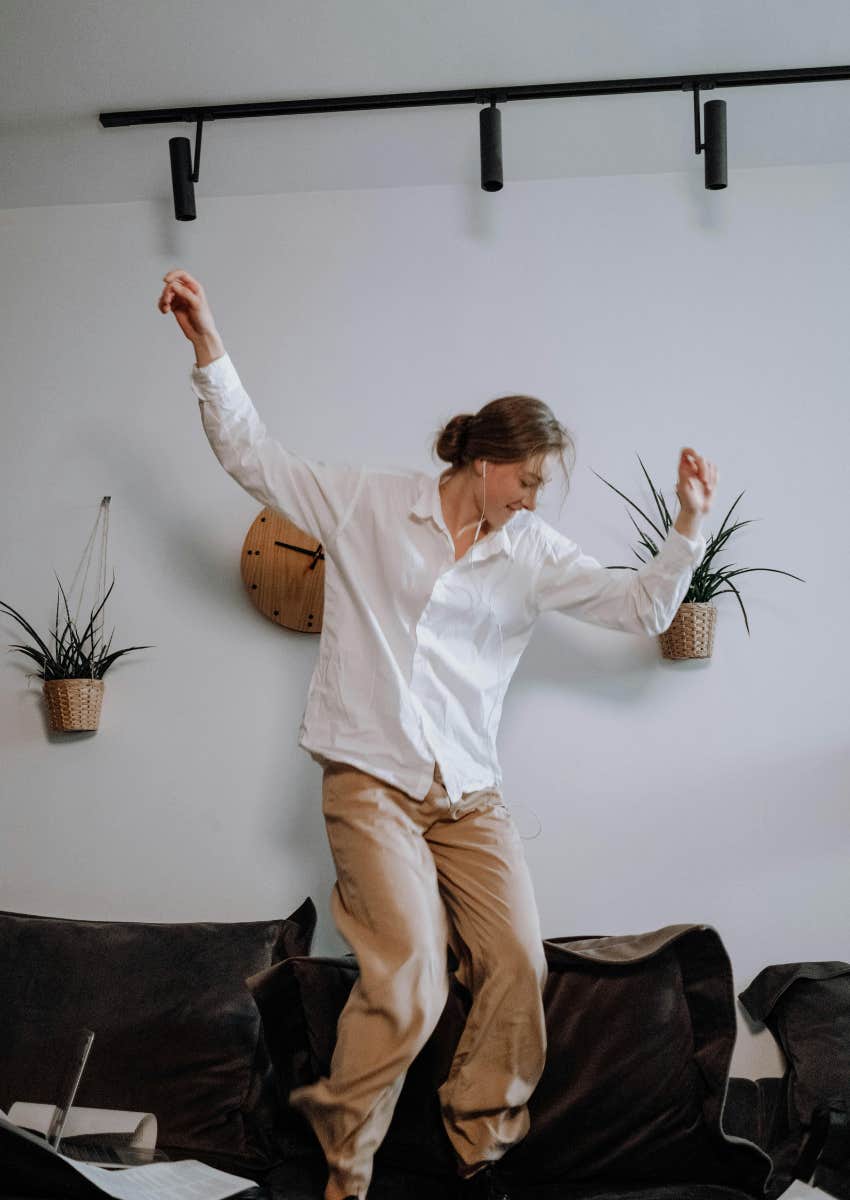 woman dancing to music on Spotify