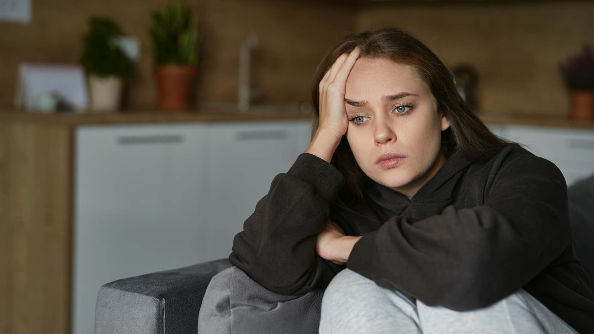 woman in black shirt looking upset as nobody checks in with them