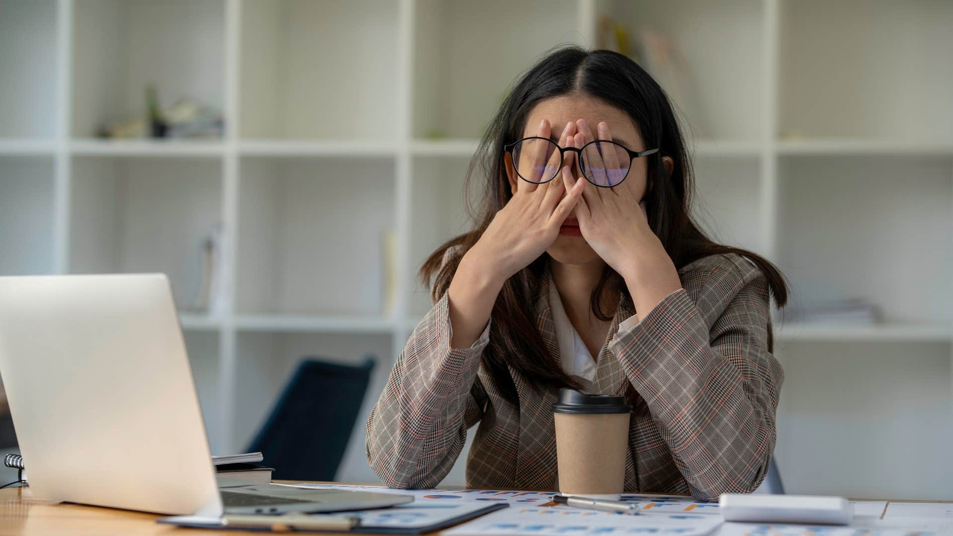 woman in brown looking exhausted as they're burned out
