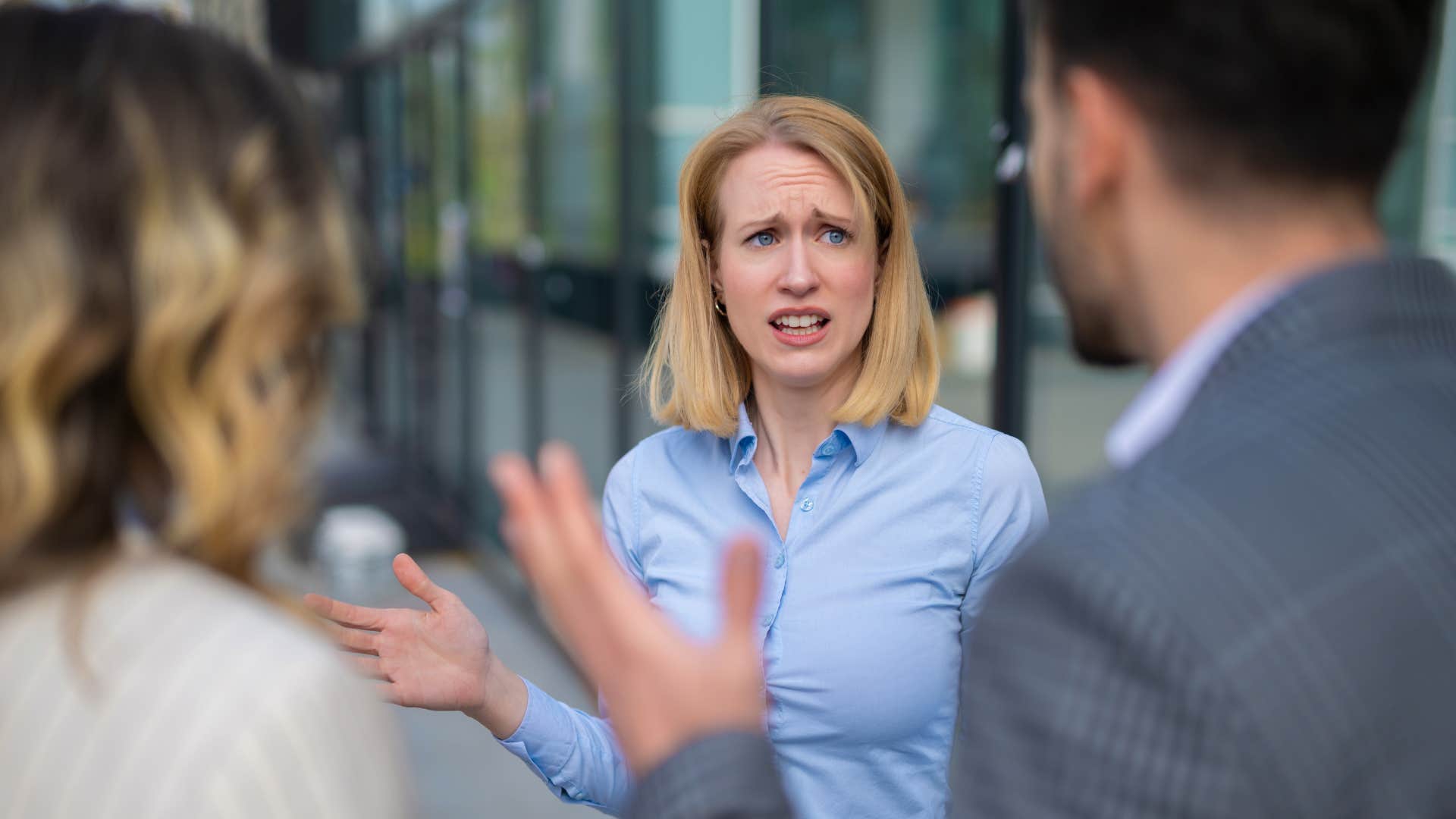 immature woman reacting with anger to colleagues